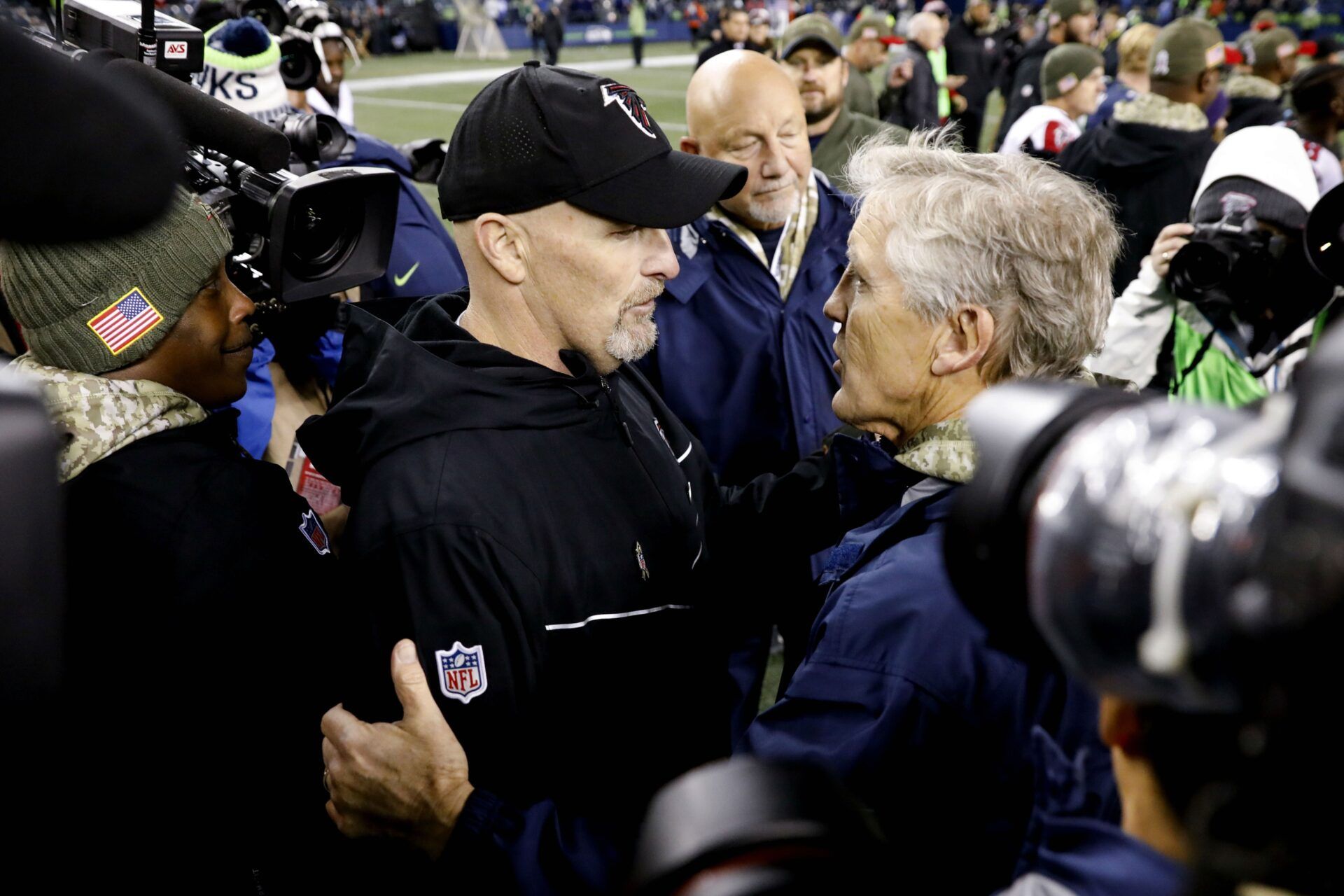 Atlanta Falcons head coach Dan Quinn (left) talks with Seattle Seahawks head coach Pete Carroll following a 34-31 Atlanta victory at CenturyLink Field.