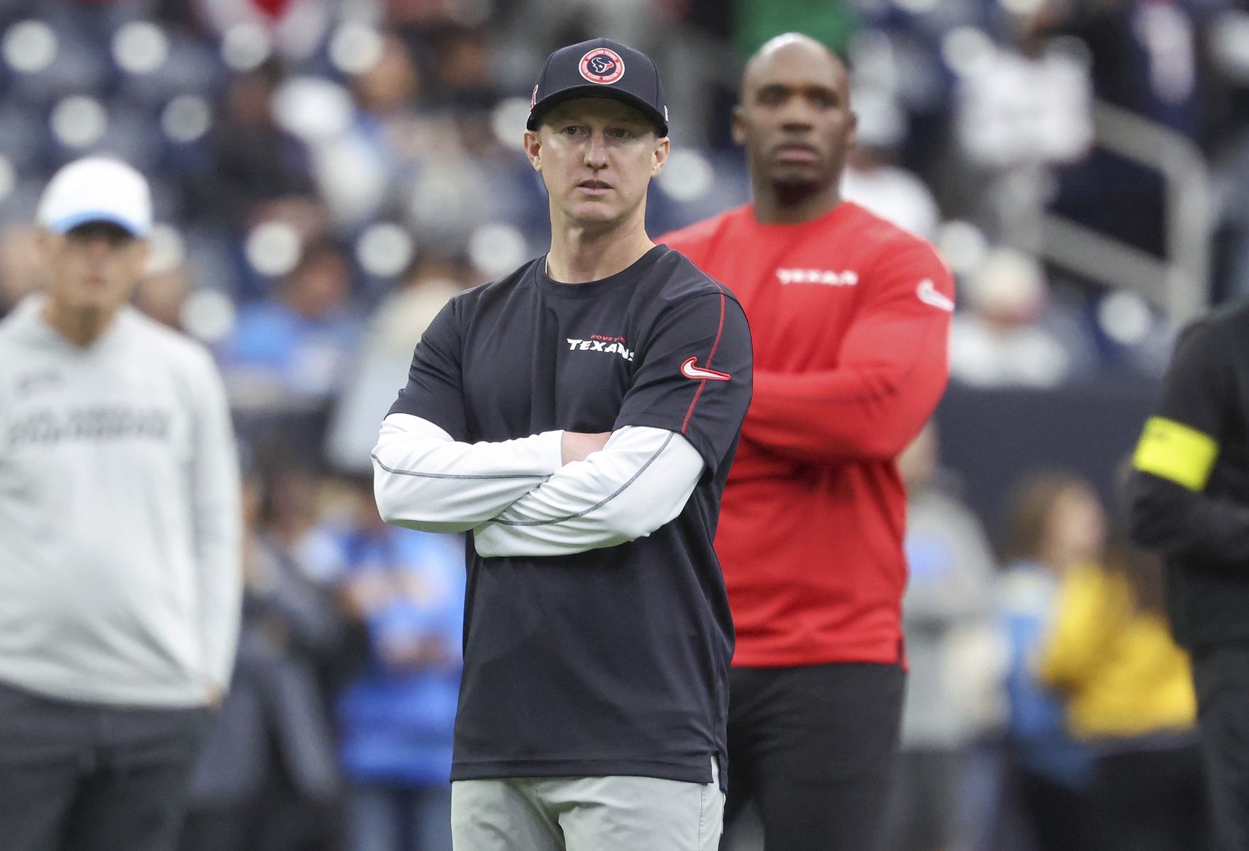 Houston Texans offensive coordinator Bobby Slowik and head coach DeMeco Ryans look on before the game against the Los Angeles Chargers in an AFC wild card game at NRG Stadium.