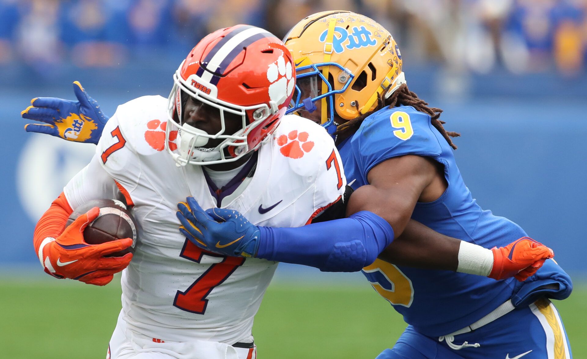 Nov 16, 2024; Pittsburgh, Pennsylvania, USA; Clemson Tigers running back Phil Mafah (7) runs the ball against Pittsburgh Panthers linebacker Kyle Louis (9) during the first quarter at Acrisure Stadium. Mandatory Credit: Charles LeClaire-Imagn Images