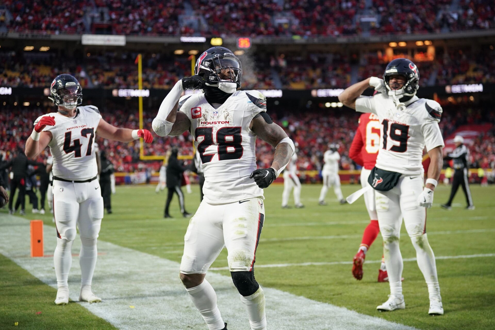 Houston Texans running back Joe Mixon (28) celebrates with fullback Andrew Beck (47) and wide receiver Xavier Hutchinson (19) after scoring a touchdown against the Kansas City Chiefs during the third quarter of a 2025 AFC divisional round game at GEHA Field at Arrowhead Stadium.