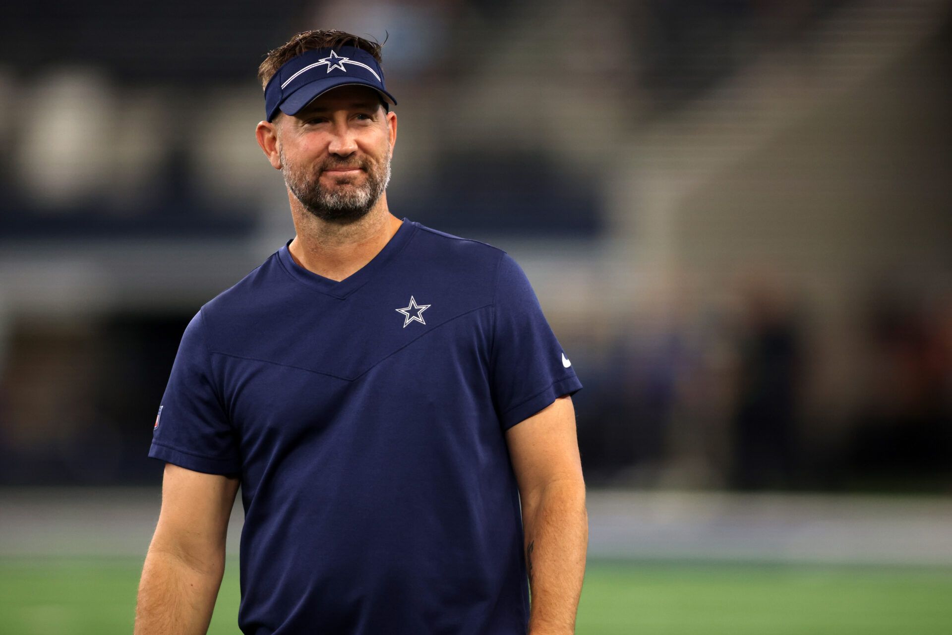 Aug 26, 2023; Arlington, Texas, USA; Dallas Cowboys offensive coordinator Brian Schottenheimer on the field before the game against the Las Vegas Raiders at AT&T Stadium. Mandatory Credit: Tim Heitman-USA TODAY Sports