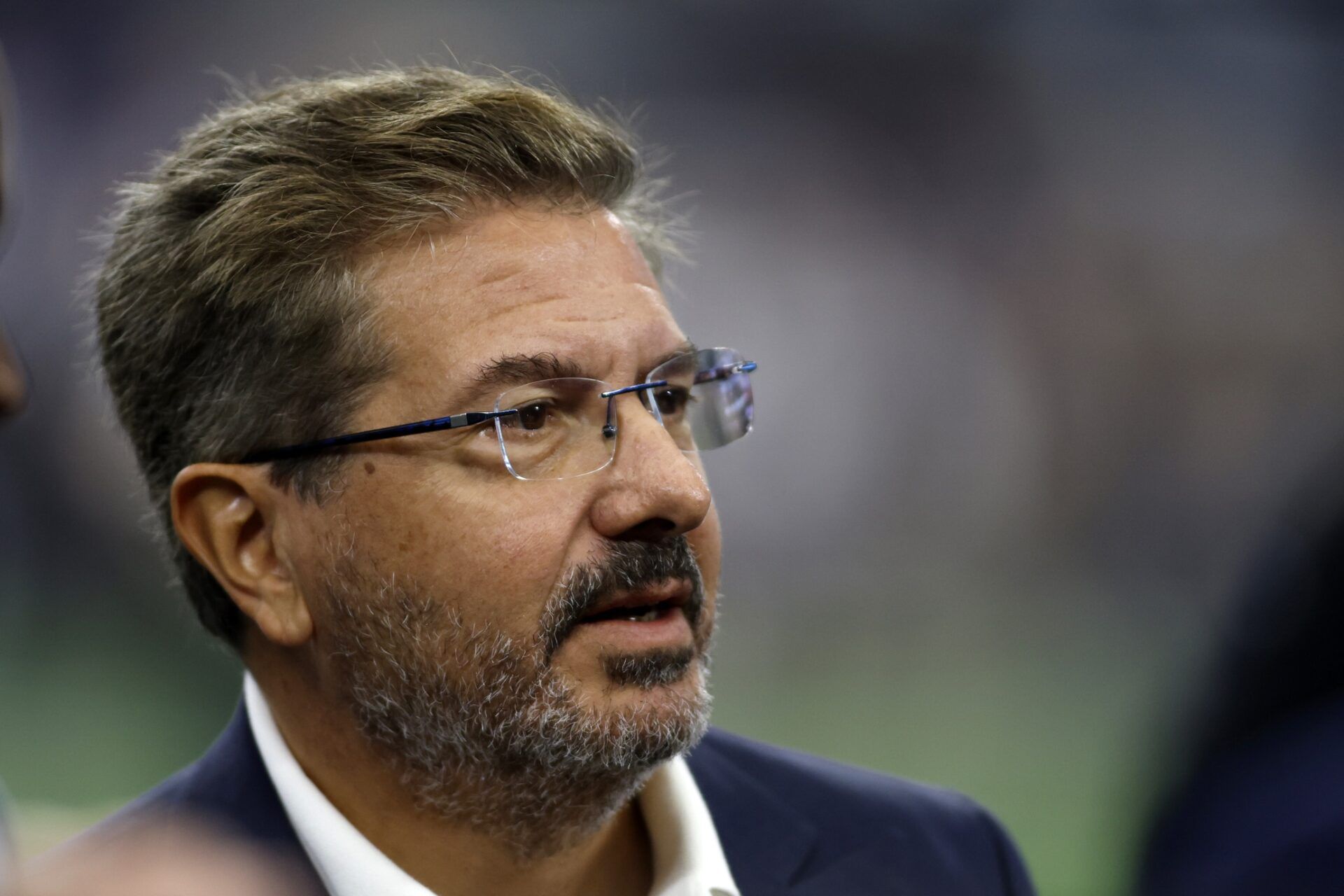 Washington Commanders owner Dan Snyder on the field before the game against the Dallas Cowboys at AT&T Stadium.