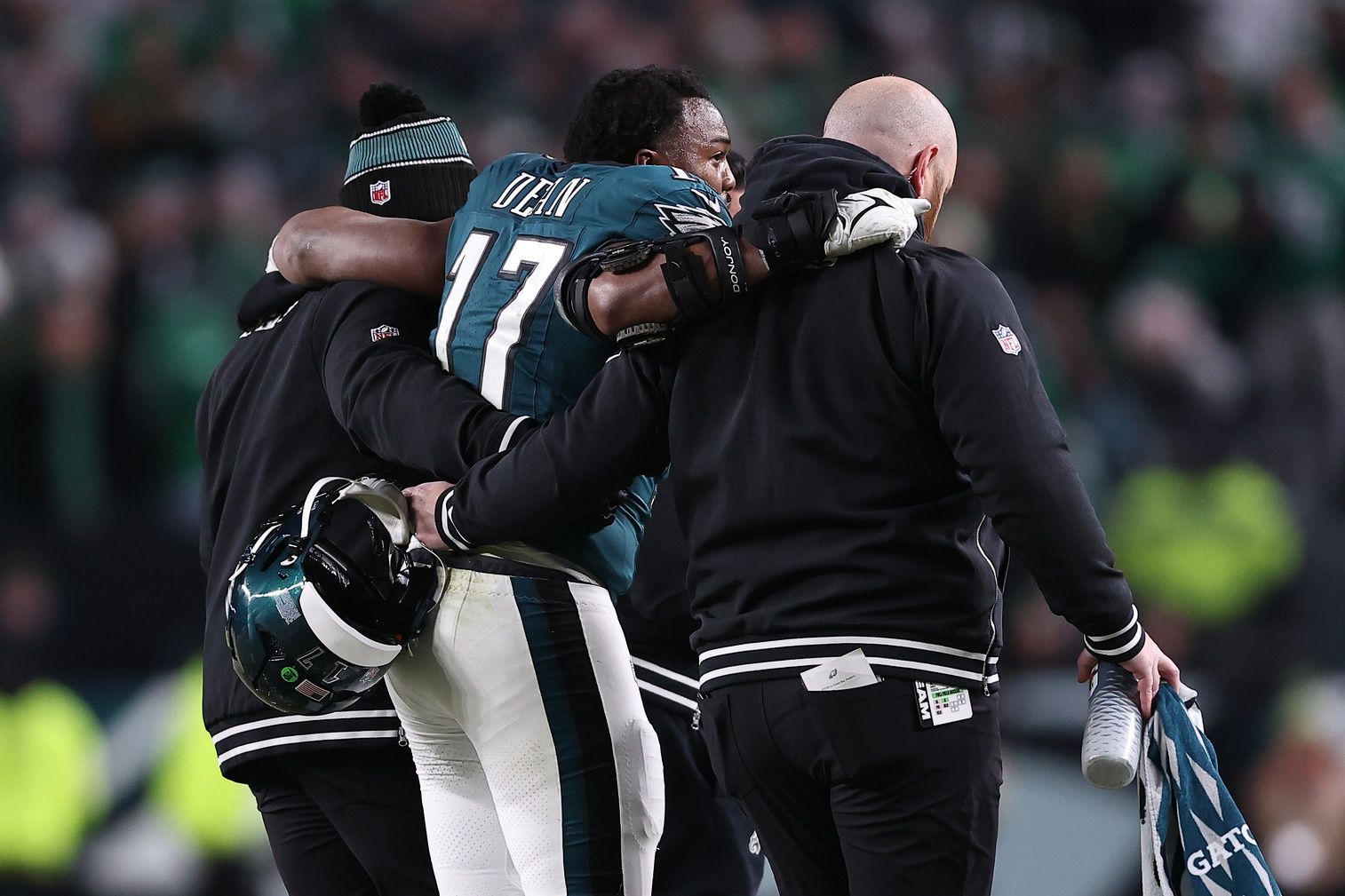 Philadelphia Eagles linebacker Nakobe Dean (17) is helped off the field against the Green Bay Packers during the first half in an NFC wild card game at Lincoln Financial Field.