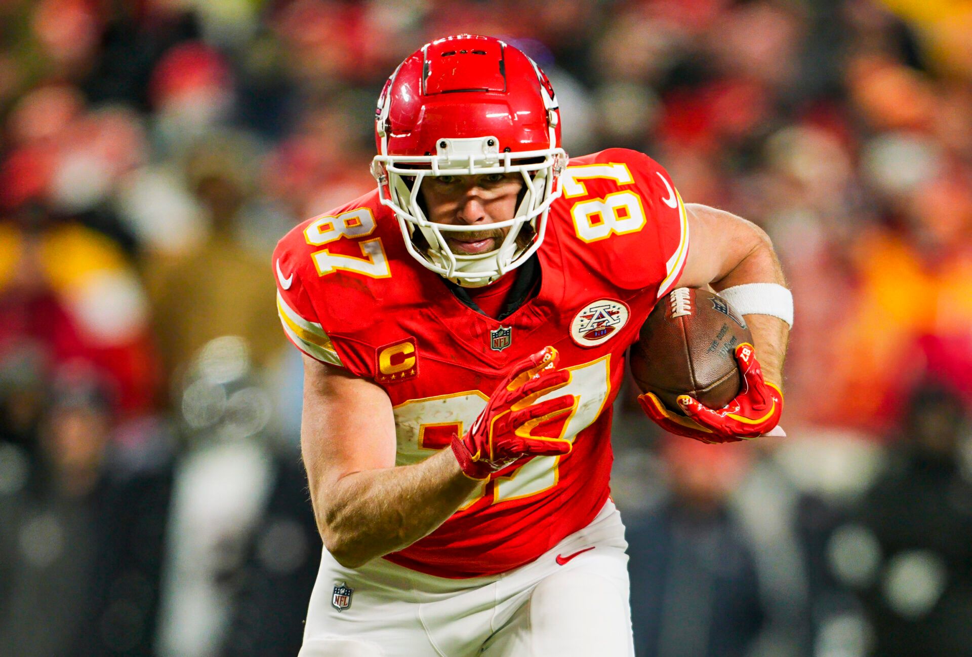 Jan 18, 2025; Kansas City, Missouri, USA; Kansas City Chiefs tight end Travis Kelce (87) runs with the ball during the second half against Houston Texans in a 2025 AFC divisional round game at GEHA Field at Arrowhead Stadium. Mandatory Credit: Jay Biggerstaff-Imagn Images