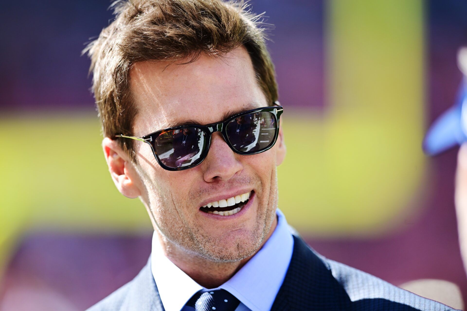 Fox Sports broadcaster Tom Brady talks on the field before the game between the Cleveland Browns and the Dallas Cowboys at Huntington Bank Field.