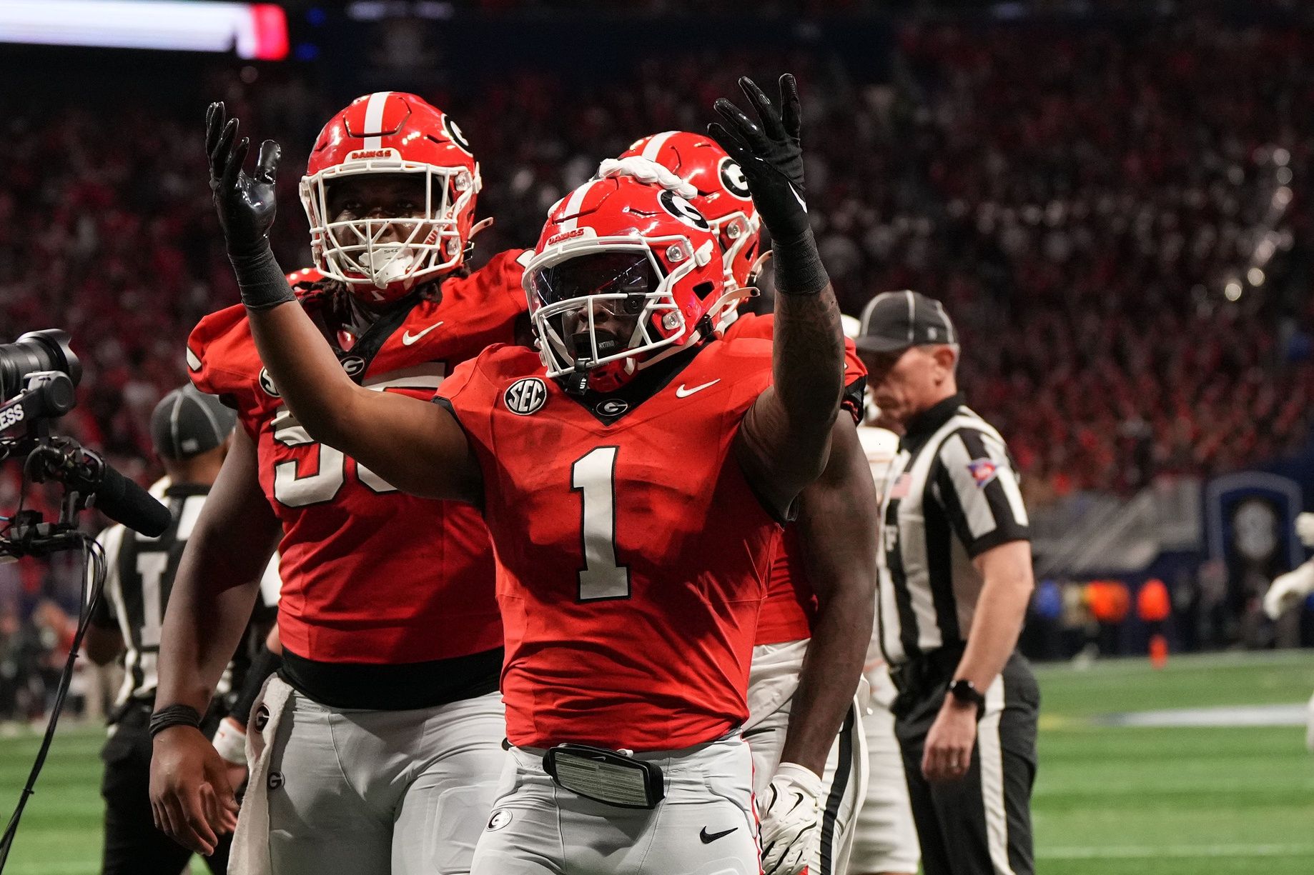 Georgia Bulldogs running back Trevor Etienne (1) reacts after rushing for a touchdown against the Texas Longhorns during the second half in the 2024 SEC Championship game at Mercedes-Benz Stadium.