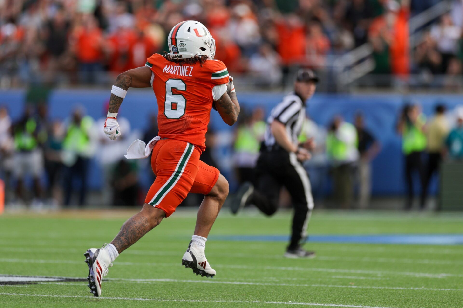 Miami Hurricanes running back Damien Martinez (6) runs for a touchdown against the Iowa State Cyclones in the first quarter during the Pop Tarts bowl at Camping World Stadium.