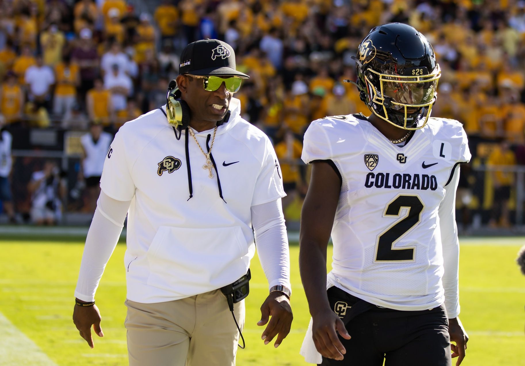 Colorado Buffaloes head coach Deion Sanders with son and quarterback Shedeur Sanders (2) against the Arizona State Sun Devils at Mountain America Stadium.