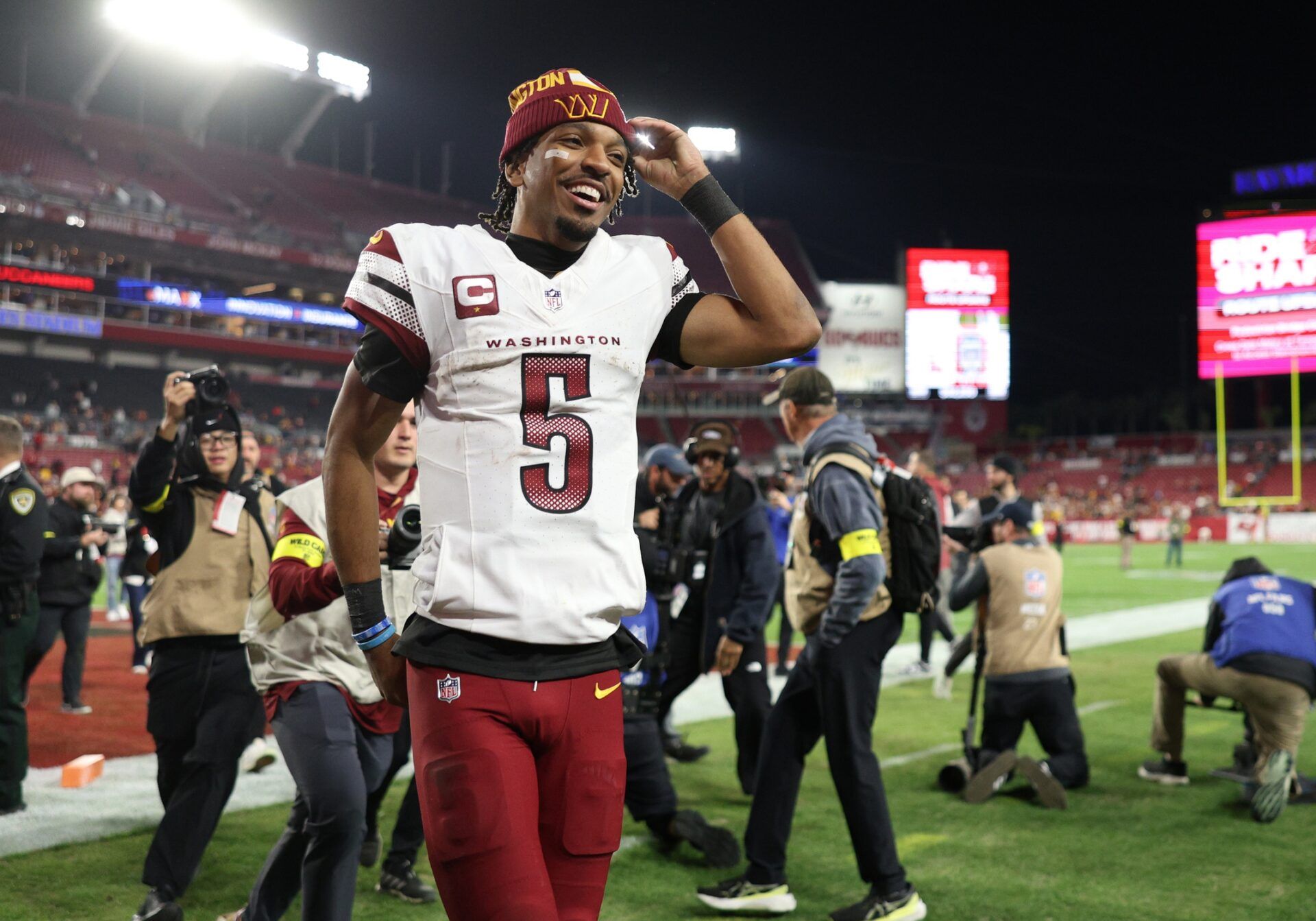 Washington Commanders quarterback Jayden Daniels (5) celebrates after winning a NFC wild card playoff against the Tampa Bay Buccaneers at Raymond James Stadium.