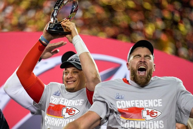 Patrick Mahomes raises the Lamar Hunt Trophy while Travis Kelce celebrates after the Kansas City Chiefs' 23-20 win over the Cincinnati Bengals in the AFC championship game at Arrowhead Stadium.