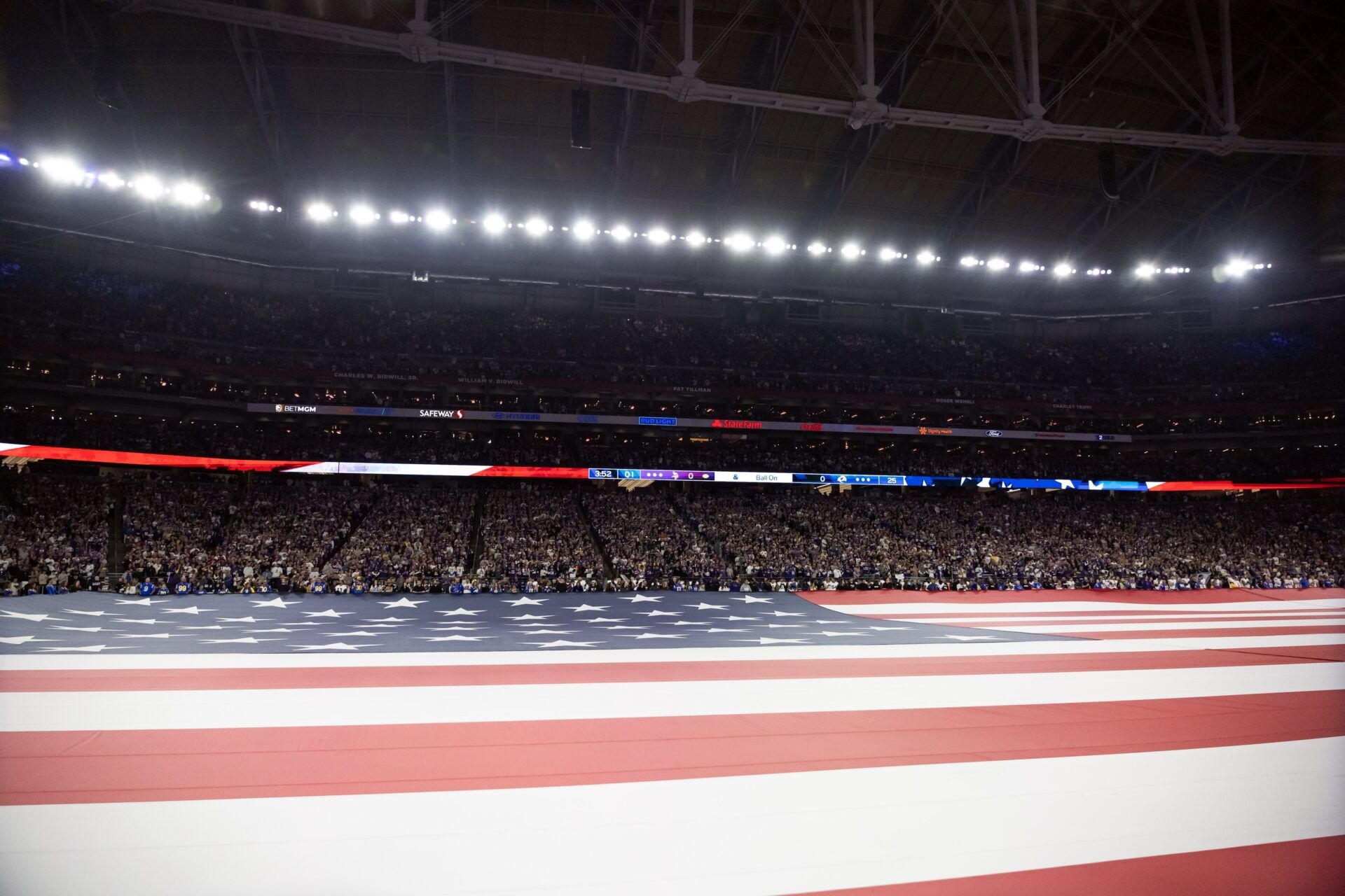 General view of the American flag displayed on the field during the national anthem prior to the Minnesota Vikings game against the Los Angeles Rams in an NFC wild card game at State Farm Stadium.