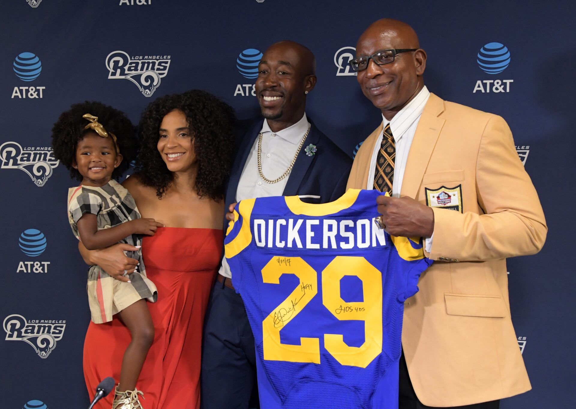 Los Angeles Rams former running back Eric Dickerson (right), wearing a Pro Football Hall of Fame gold jacket, poses with daughter Erica Dickerson and son-in-law Freddie Gibbs and granddaughter during a press conference after signing a one-day contract to retire as a member of the Rams at Cal Lutheran University.