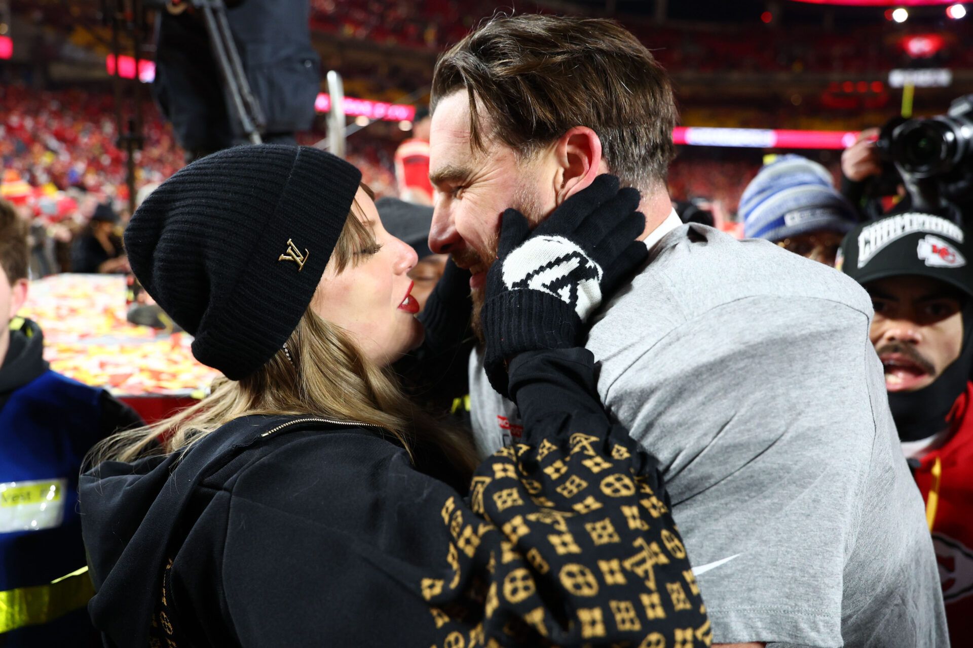 Jan 26, 2025; Kansas City, MO, USA; Recording artist Taylor Swift and Kansas City Chiefs tight end Travis Kelce (87) react after the AFC Championship game against the Buffalo Bills at GEHA Field at Arrowhead Stadium. Mandatory Credit: Mark J. Rebilas-Imagn Images