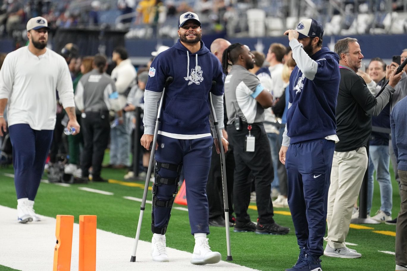 Dallas Cowboys quarterback Dak Prescott (left) stands on crutches before the game against the New York Giants at AT&T Stadium.