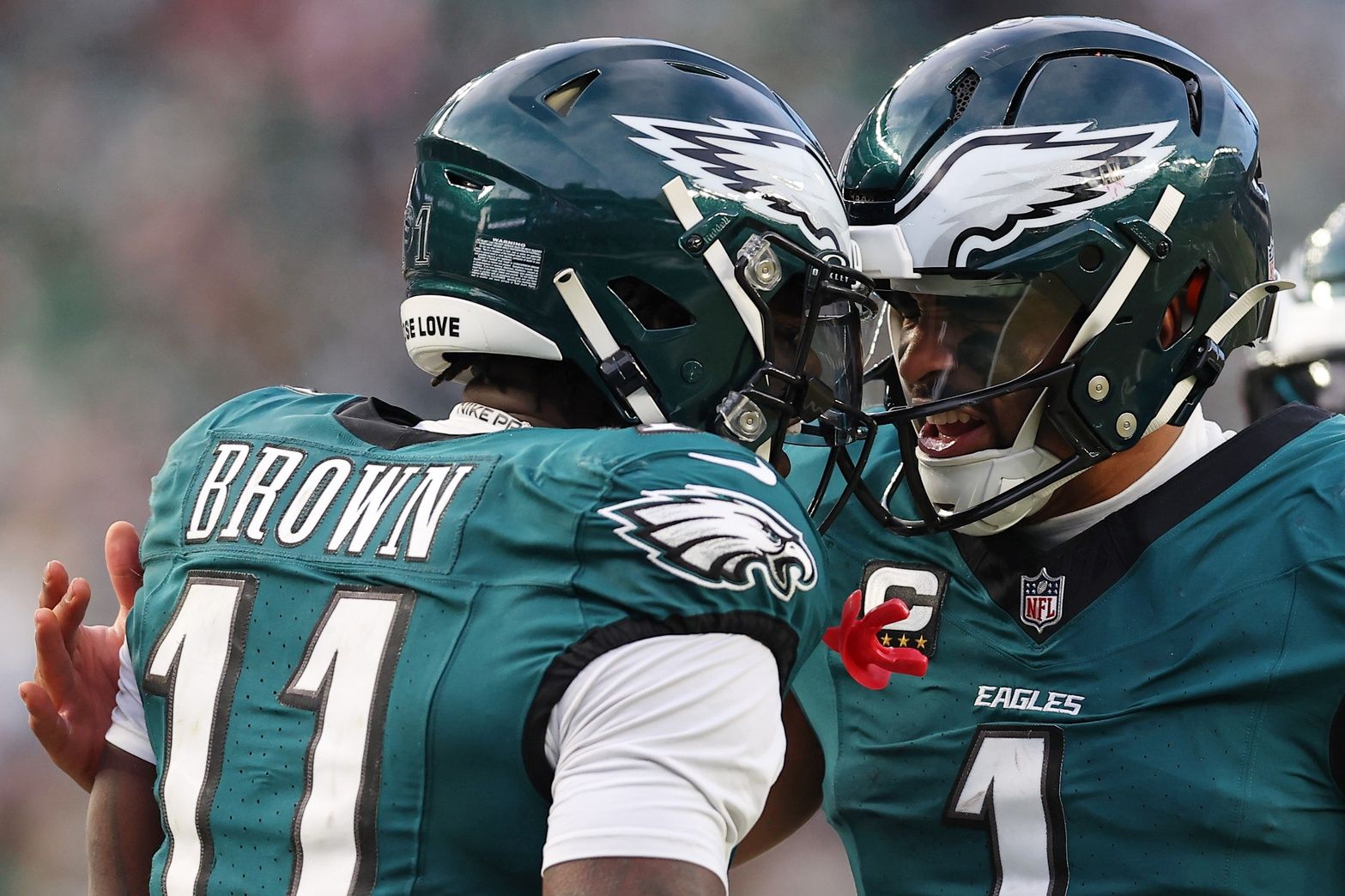 Philadelphia Eagles quarterback Jalen Hurts (1) and wide receiver A.J. Brown (11) celebrate after a touchdown against the Washington Commanders during the first half in the NFC Championship game at Lincoln Financial Field.