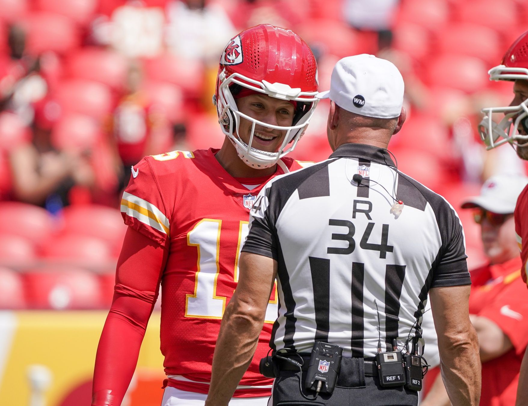 Kansas City Chiefs quarterback Patrick Mahomes (15) talks with referee Clete Blakeman (34) against the Washington Commanders prior to the game at GEHA Field at Arrowhead Stadium.