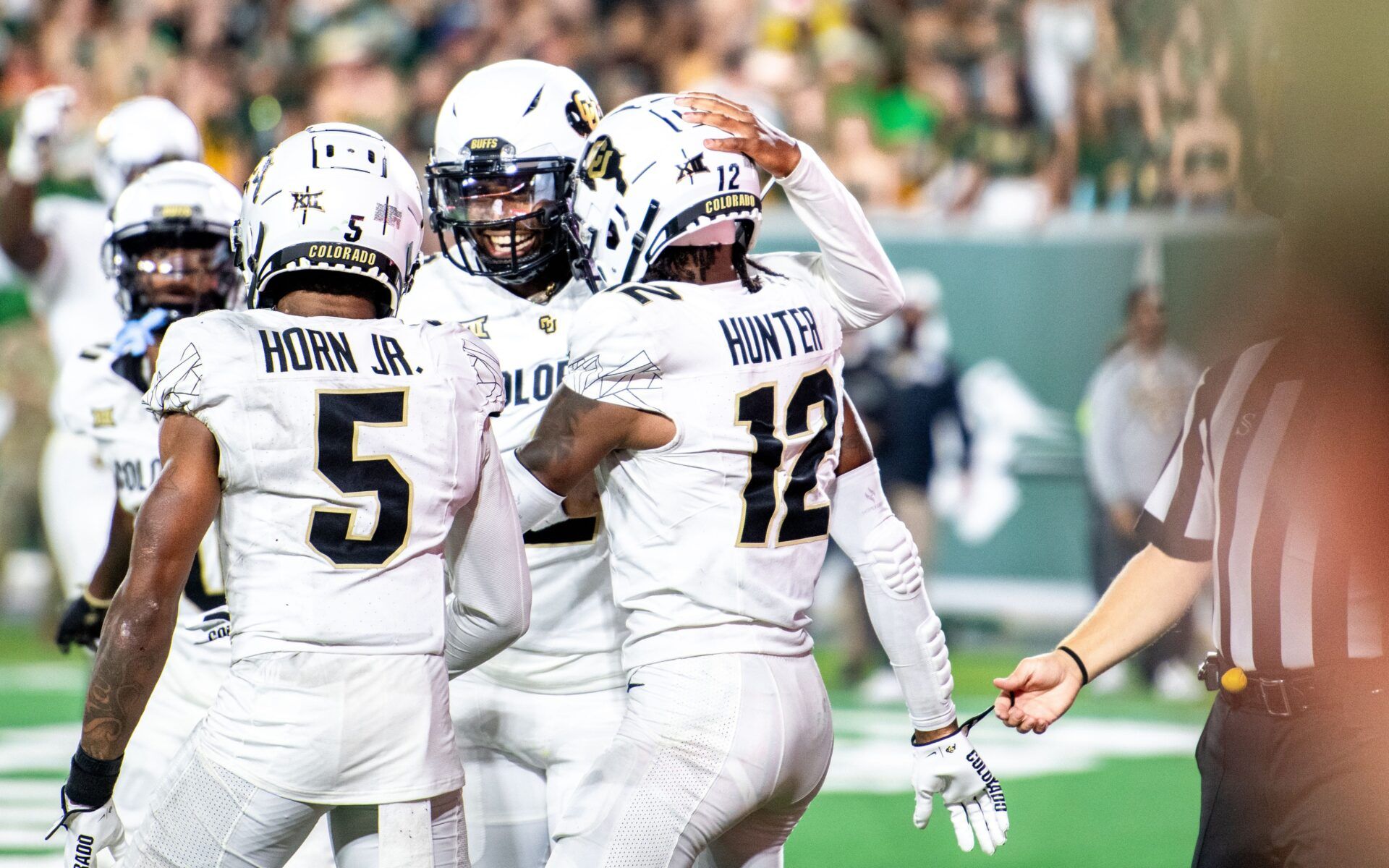 CU football athlete Travis Hunter (12), quarterback Shadeur Sanders (middle) and wide receiver Jimmy Horn Jr. celebrate Hunter's touchdown reception against CSU in the Rocky Mountain Showdown at Canvas Stadium on Saturday, Sept. 14, 2024, in Fort Collins, Colo.