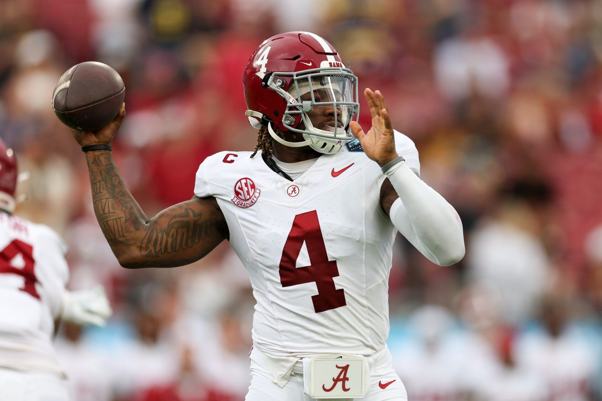 Alabama Crimson Tide quarterback Jalen Milroe (4) drops back to pass against the Michigan Wolverines in the first quarter during the ReliaQuest Bowl at Raymond James Stadium.