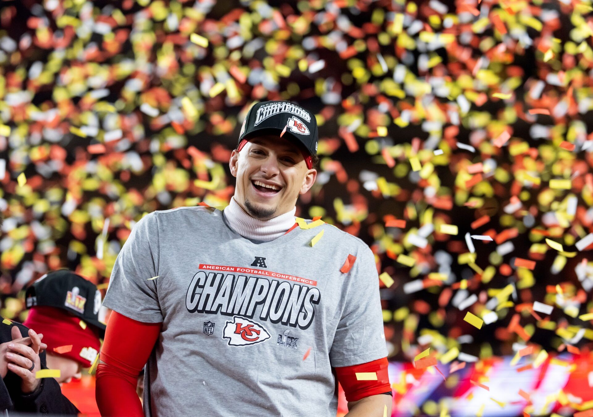 Confetti falls as Kansas City Chiefs quarterback Patrick Mahomes celebrates after defeating the Buffalo Bills during the AFC Championship game at GEHA Field at Arrowhead Stadium.