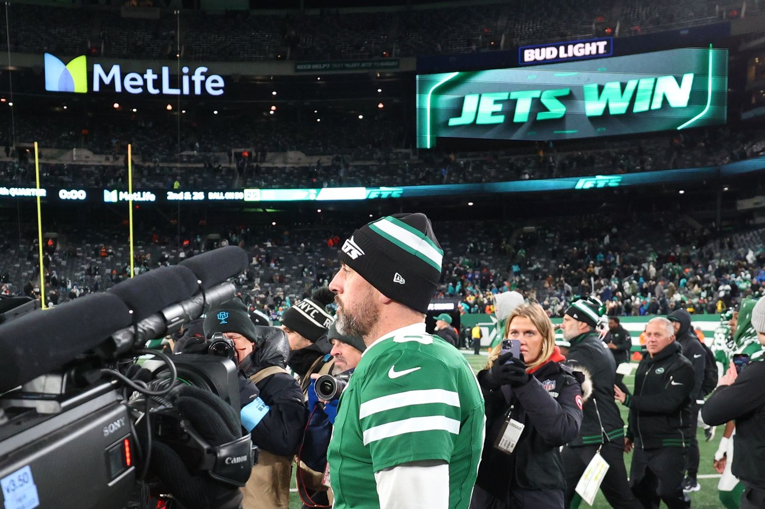 New York Jets quarterback Aaron Rodgers (8) walks on the field after the Jets win over the Miami Dolphins at MetLife Stadium.