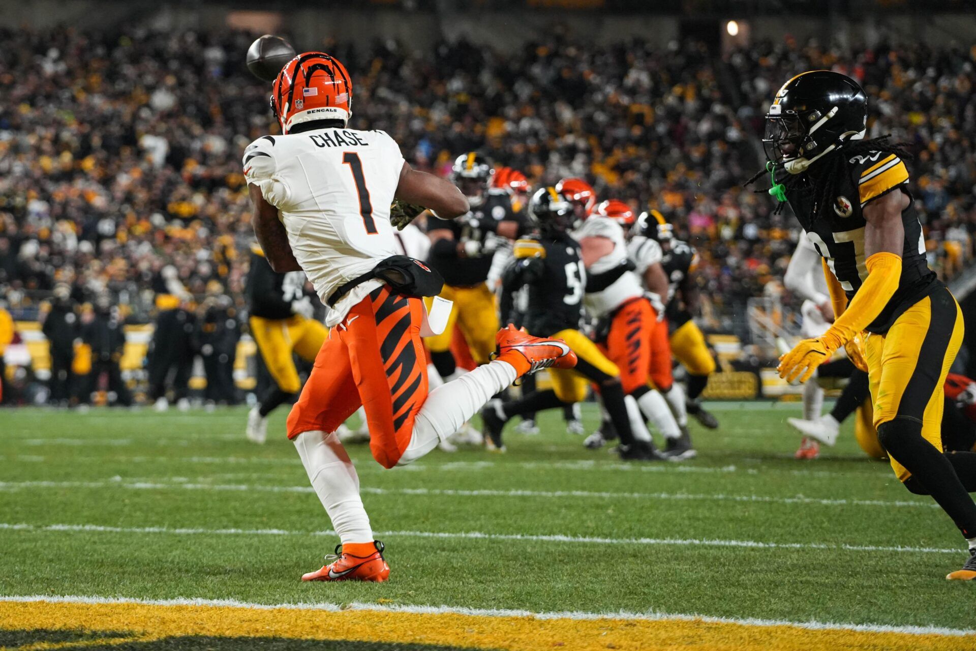 Bengals Ja'Marr Chase (1) catches a pass for a touchdown during their game against the Steelers at Acrisure Stadium on Saturday January 4, 2025. The Bengals lead the game at halftime with a score of 13-7.