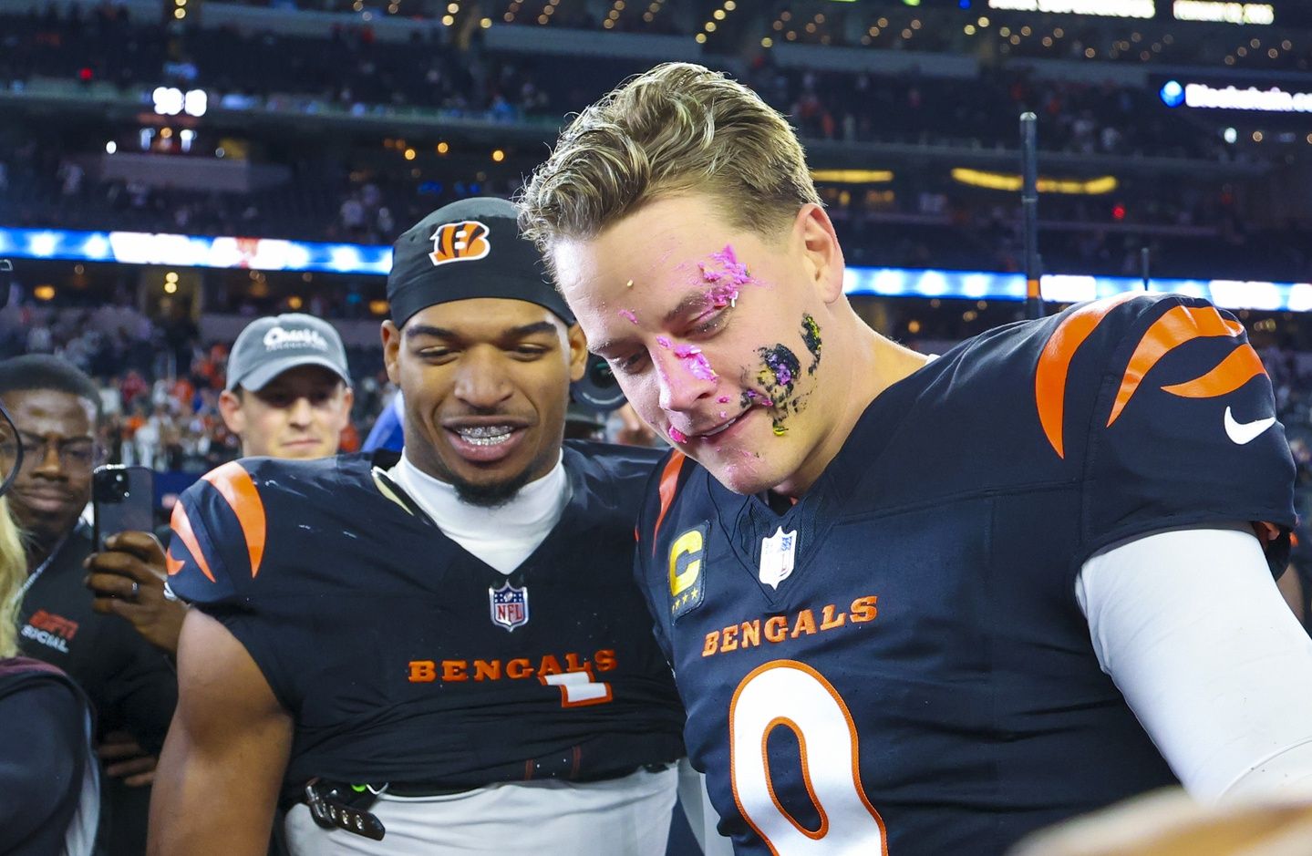 Cincinnati Bengals wide receiver Ja'Marr Chase (1) smashes a donut on the face of Cincinnati Bengals quarterback Joe Burrow (9) after the game against the Dallas Cowboys at AT&T Stadium.