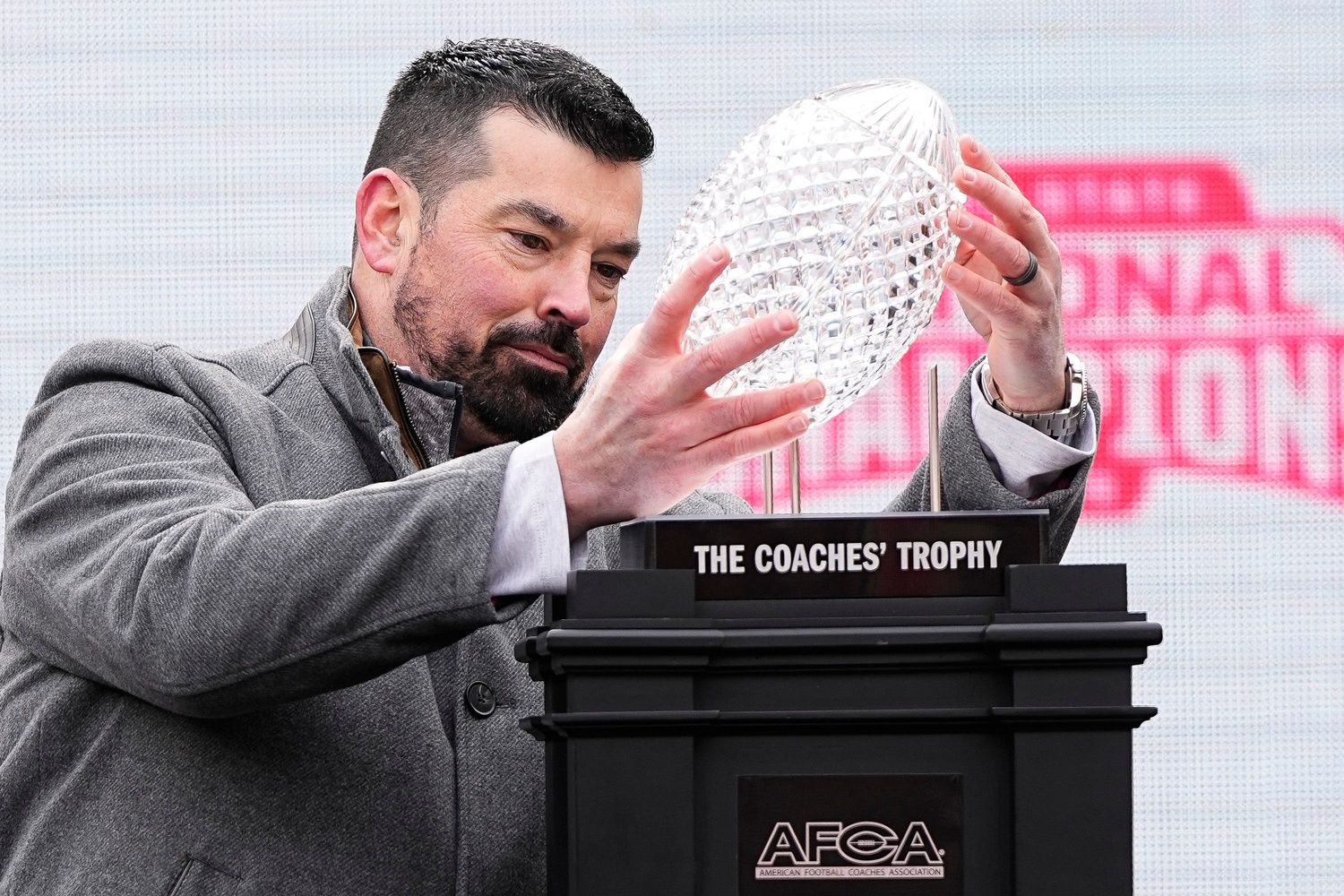 Ohio State Buckeyes head coach Ryan Day holds the AFCA Coaches' Trophy during the Ohio State Buckeyes College Football Playoff National Championship celebration at Ohio Stadium in Columbus on Jan. 26, 2025.