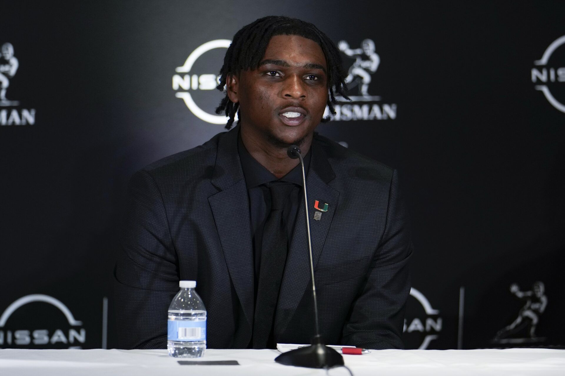 Miami Hurricanes quarterback Cam Ward speaks on stage during a press conference before the 2024 Heisman Trophy Presentation.