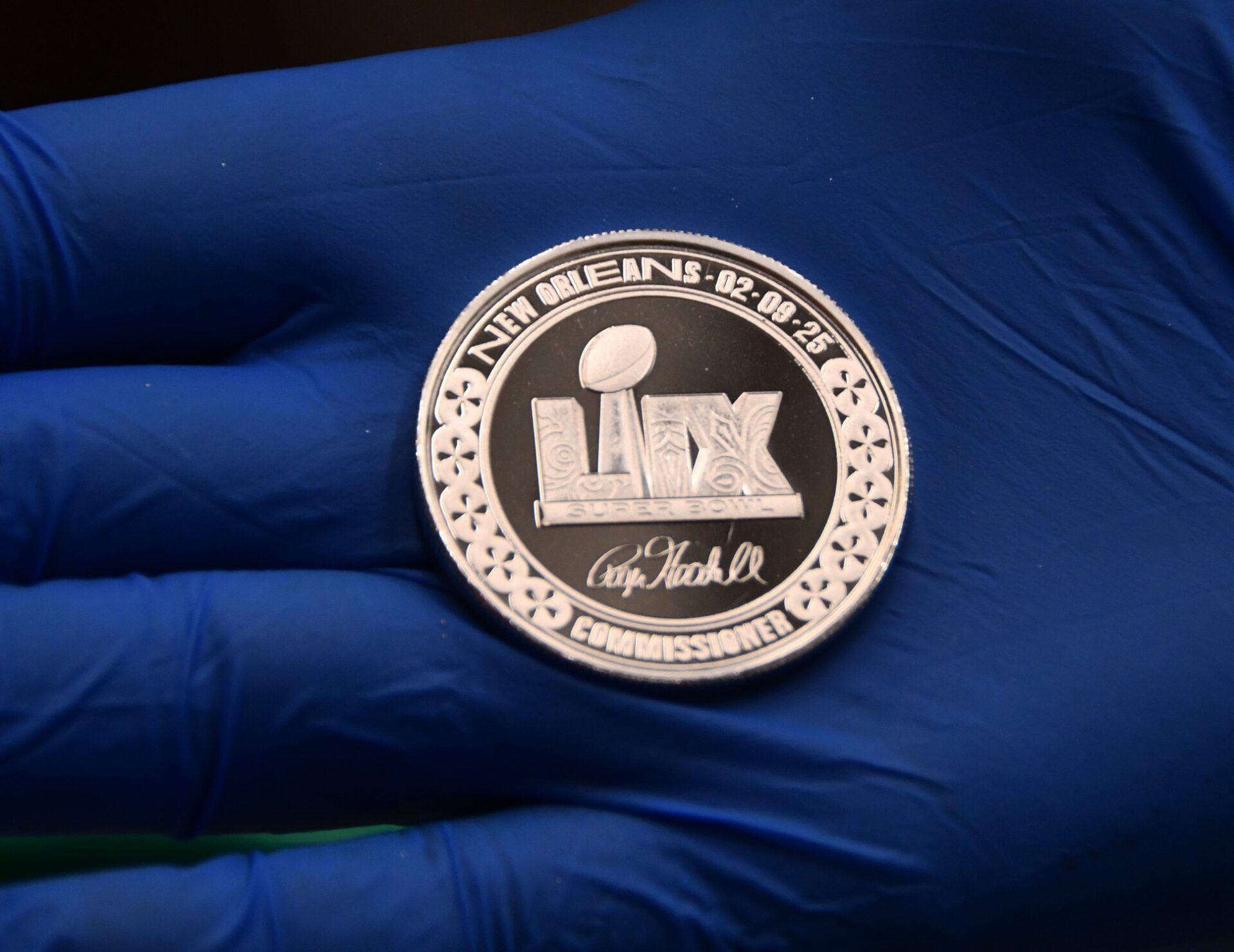 The Highland Mint in Melbourne produces the official flip coin for the Super Bowl LIX. Workers are presently working on the official flip coin, and will go into production immediately after the game to produce collectible coins for the winning team.