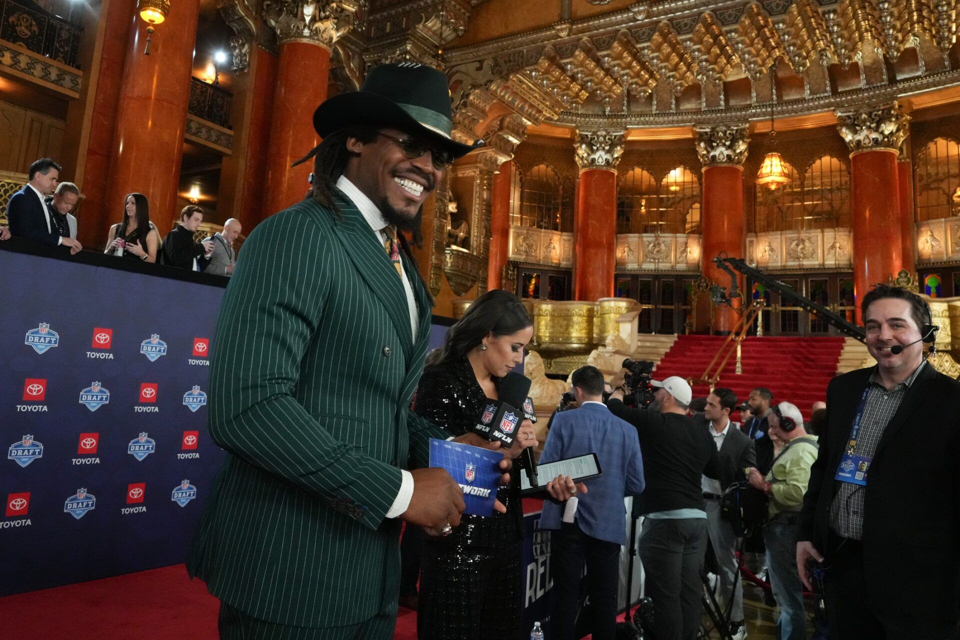 Former NFL quarterback Cam Newton stands on the red carpet ahead of the 2024 NFL Draft at Detroit’s Fox Theatre.