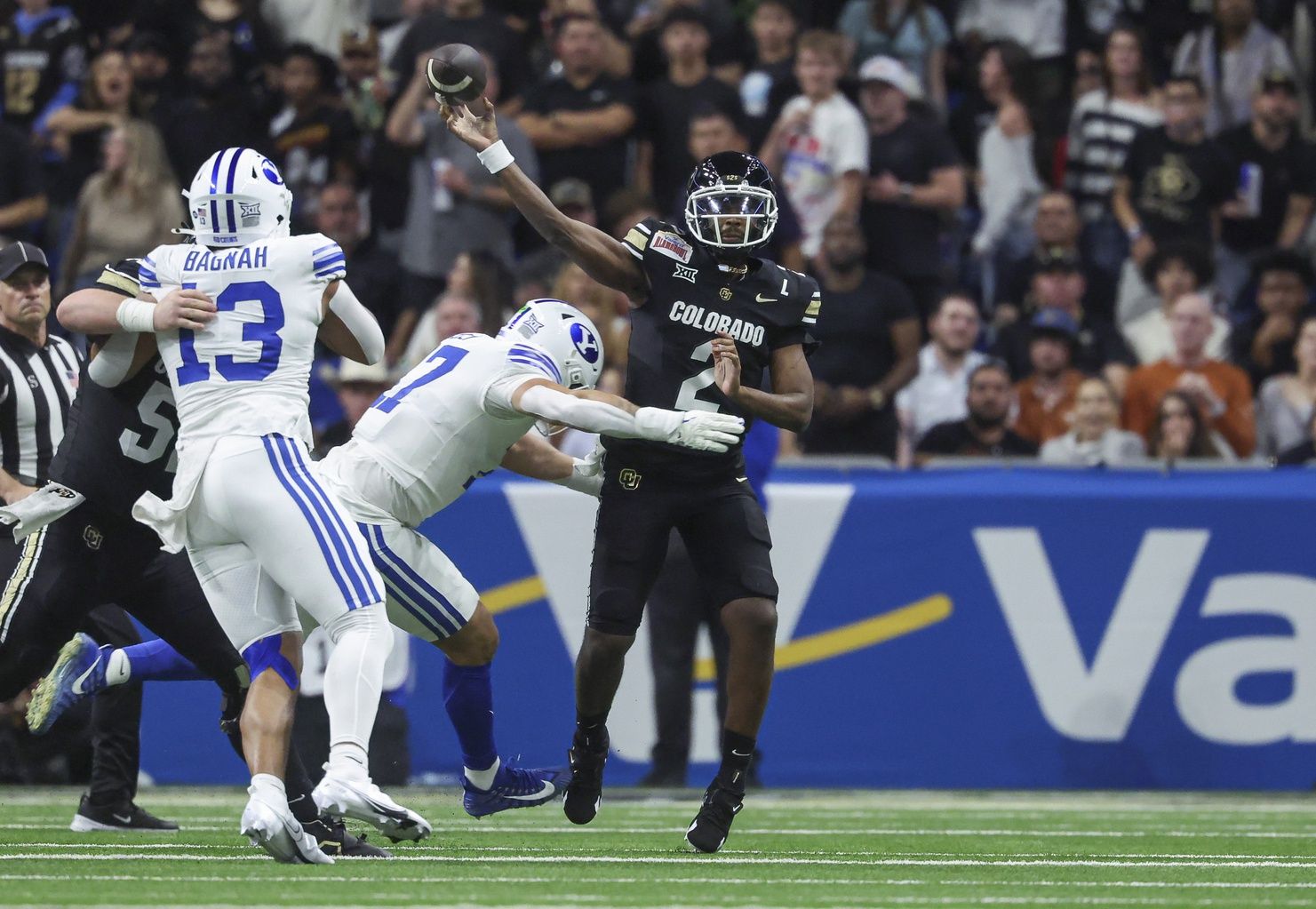 Colorado Buffaloes quarterback Shedeur Sanders (2) attempts a pass as Brigham Young Cougars linebacker Jack Kelly (17) defends during the second quarter at Alamodome.