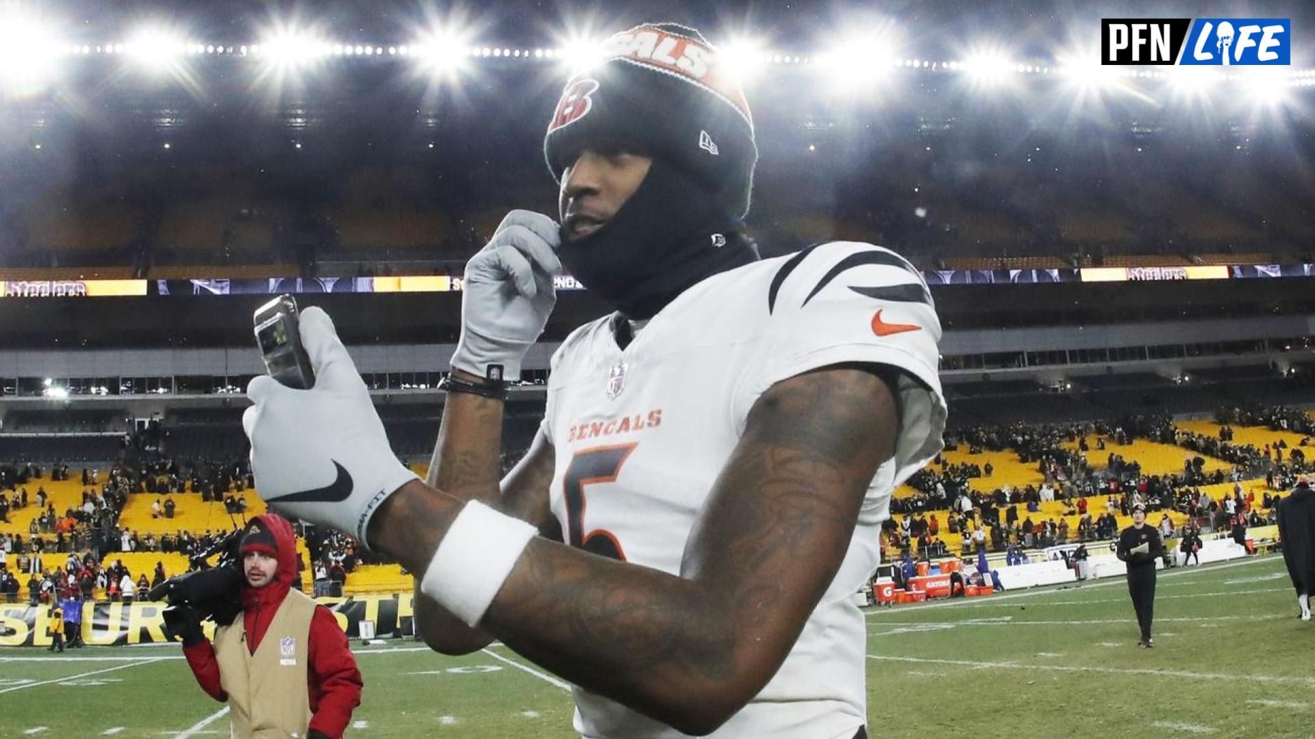 Cincinnati Bengals wide receiver Tee Higgins (5) goes live on social media after defeating the Pittsburgh Steelers at Acrisure Stadium.