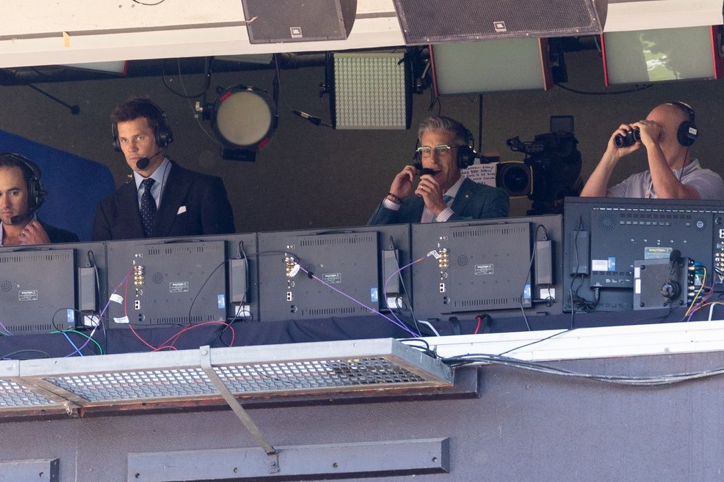 Fox Sports announcer Tom Brady, left, in the broadcast booth for the game between the Cleveland Browns and the Dallas Cowboys at Huntington Bank Field.