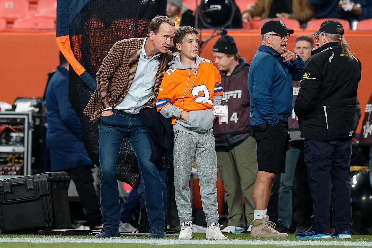 Former Denver Broncos player Peyton Manning with his son Marshall before the game against the Cleveland Browns at Empower Field at Mile High.