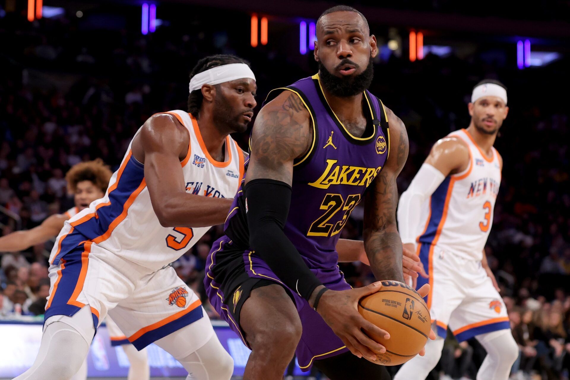 Los Angeles Lakers forward LeBron James (23) controls the ball against New York Knicks forward Precious Achiuwa (5) and guard Josh Hart (3) during the third quarter at Madison Square Garden.