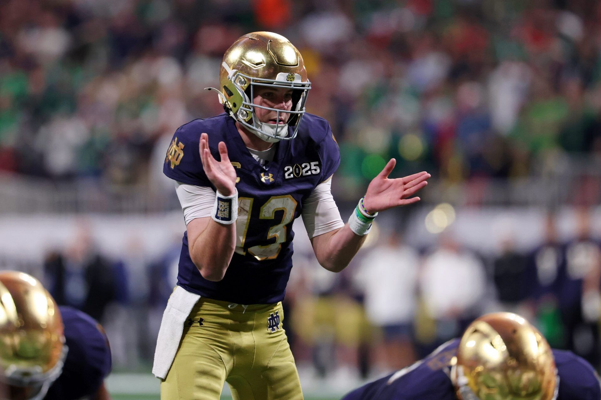 Notre Dame Fighting Irish quarterback Riley Leonard (13) prepares to snap the ball against the Ohio State Buckeyes during the first half the CFP National Championship college football game at Mercedes-Benz Stadium.