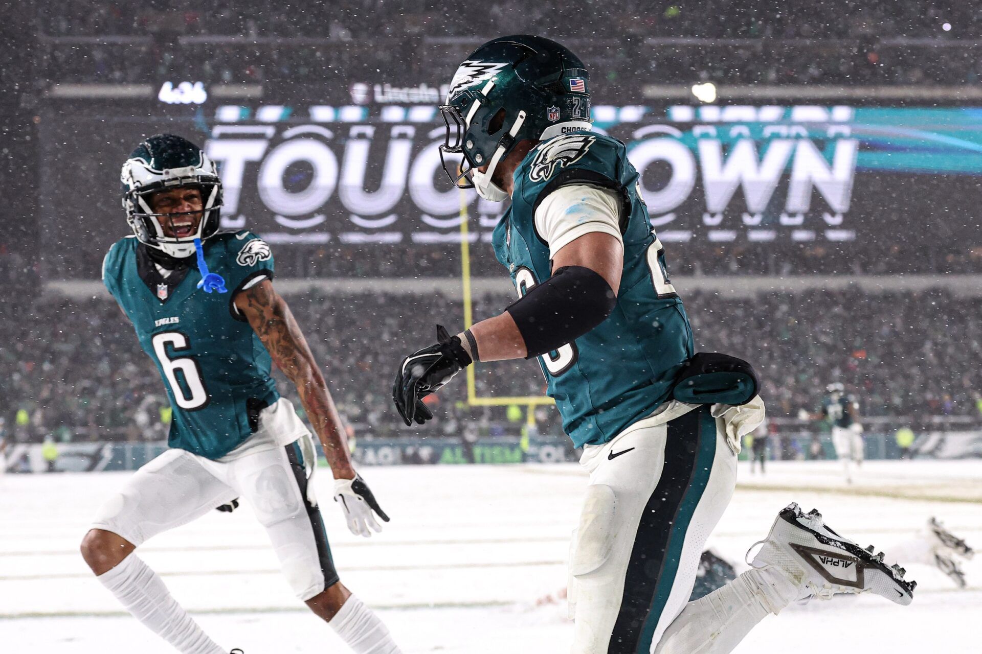 Philadelphia Eagles running back Saquon Barkley (26) celebrates alongside wide receiver DeVonta Smith (6) after his touchdown run during the fourth quarter against the Los Angeles Rams in a 2025 NFC divisional round game at Lincoln Financial Field.