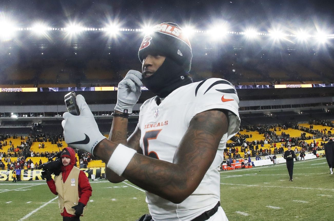 Cincinnati Bengals wide receiver Tee Higgins (5) goes live on social media after defeating the Pittsburgh Steelers at Acrisure Stadium.