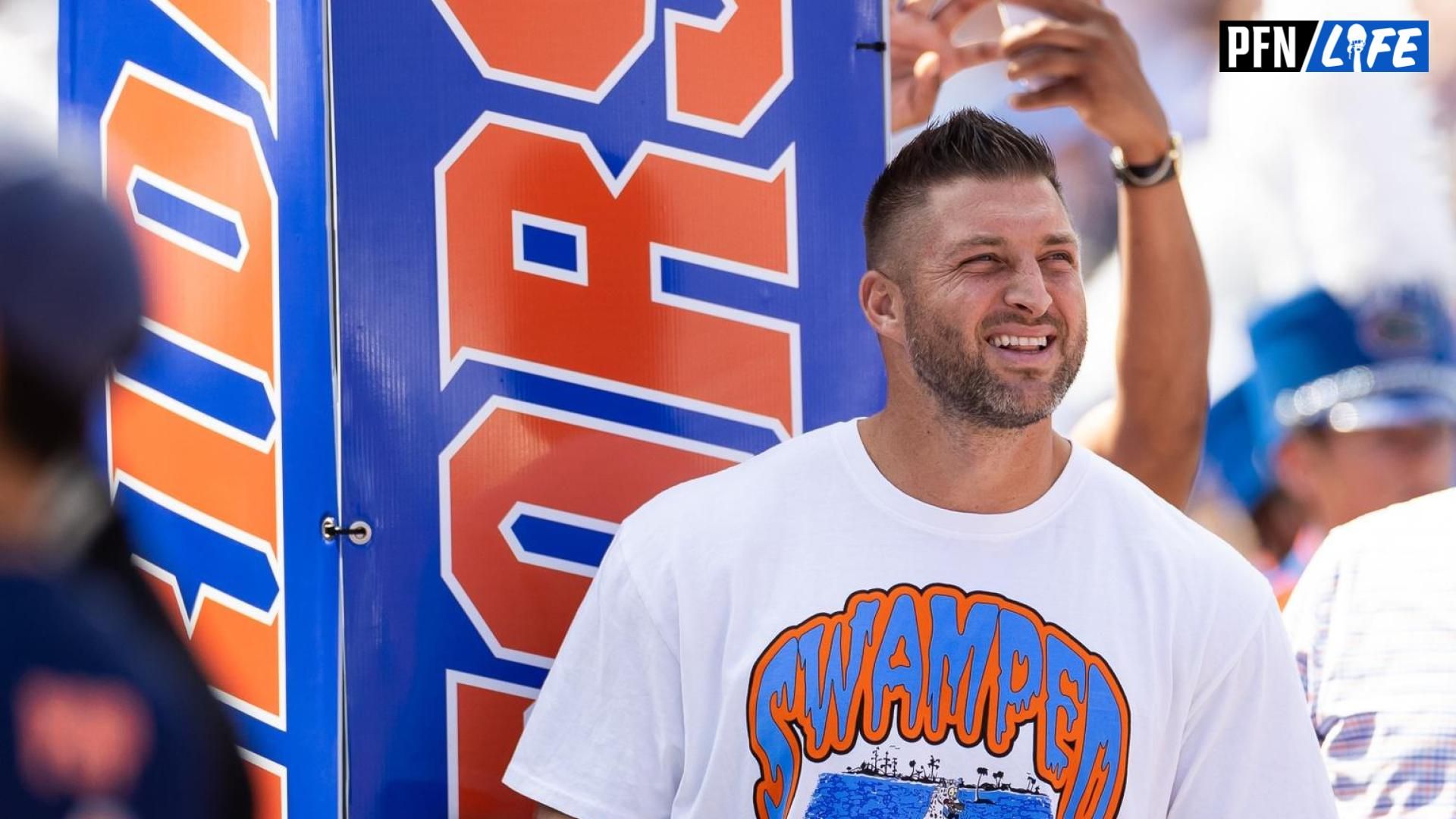 Former Florida Gators quarterback Tim Tebow (15) watches team introductions against the Miami Hurricanes before the game at Ben Hill Griffin Stadium.