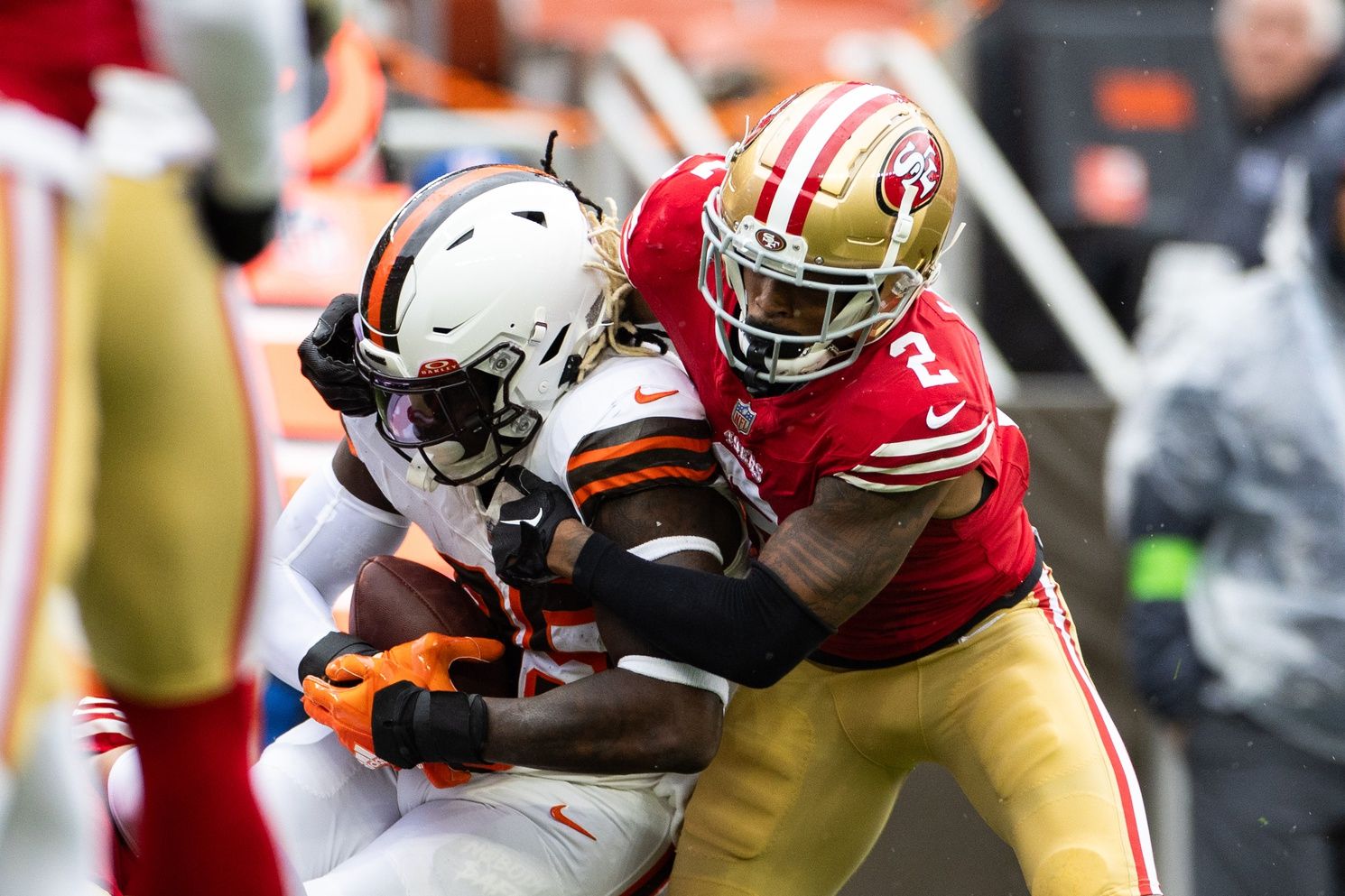 Oct 15, 2023; Cleveland, Ohio, USA; San Francisco 49ers cornerback Deommodore Lenoir (2) tackles Cleveland Browns tight end David Njoku (85) during the second quarter at Cleveland Browns Stadium. Mandatory Credit: Scott Galvin-USA TODAY Sports