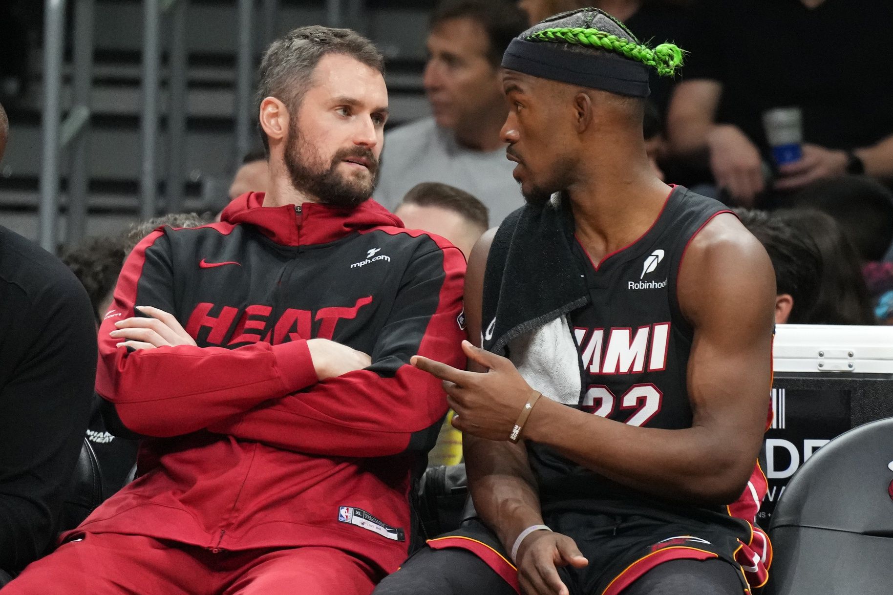 Miami Heat forward Jimmy Butler (22) talks with forward Kevin Love (42) on the bench during the second half against the Indiana Pacers at Kaseya Center.