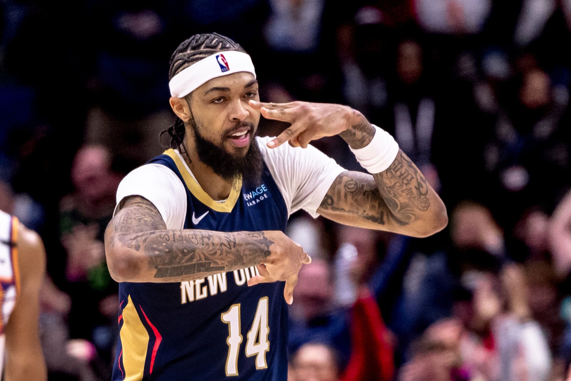 Dec 5, 2024; New Orleans, Louisiana, USA; New Orleans Pelicans forward Brandon Ingram (14) reacts to making a three point basket against the Phoenix Suns during the first half at Smoothie King Center. Mandatory Credit: Stephen Lew-Imagn Images