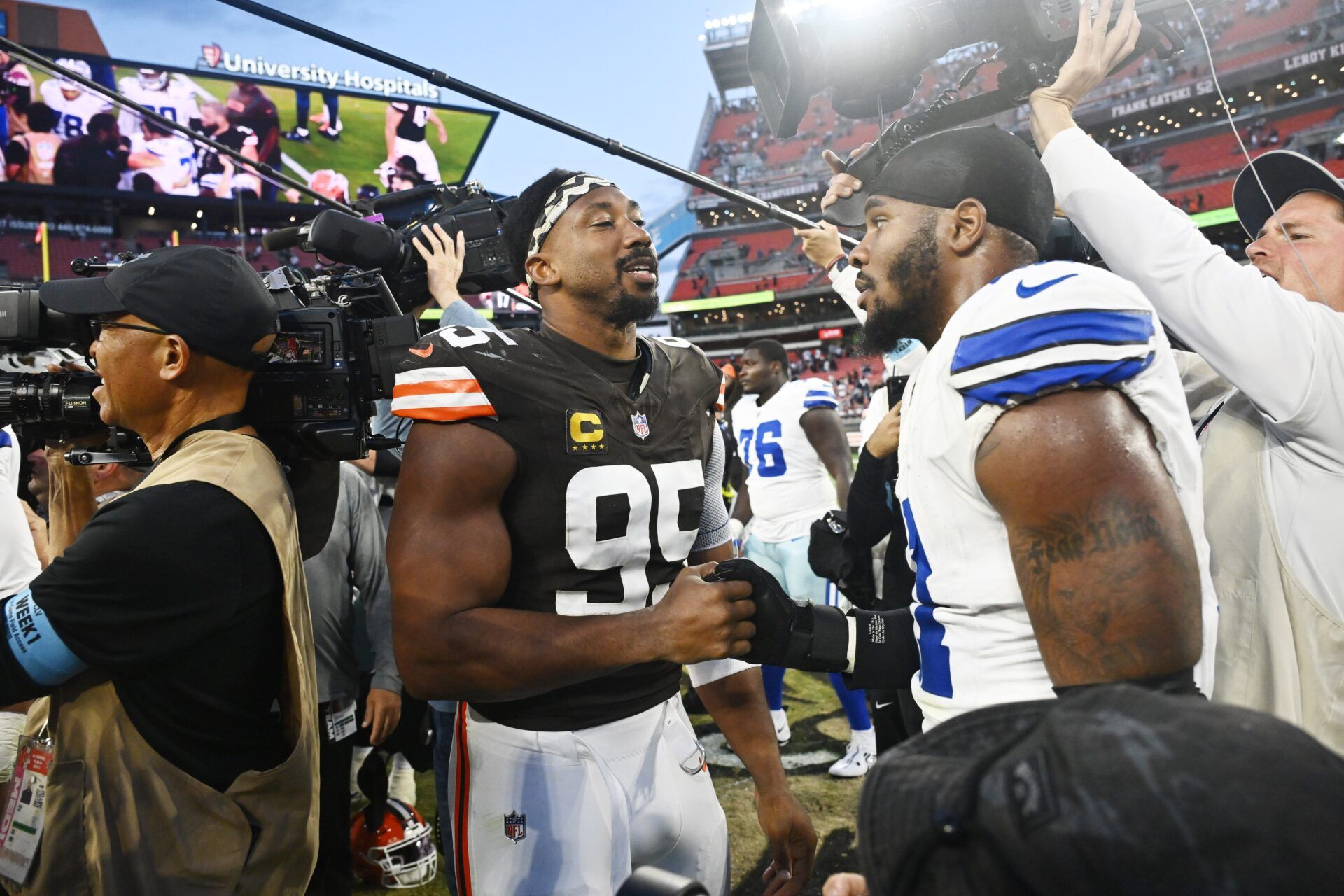 Cleveland Browns defensive end Myles Garrett (95) talks to Dallas Cowboys linebacker Micah Parsons (11) after the game at Huntington Bank Field.