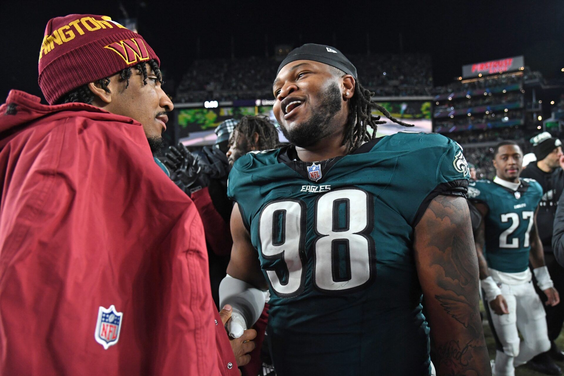 Washington Commanders quarterback Jayden Daniels (5) and Philadelphia Eagles defensive tackle Jalen Carter (98) after the NFC Championship game at Lincoln Financial Field.