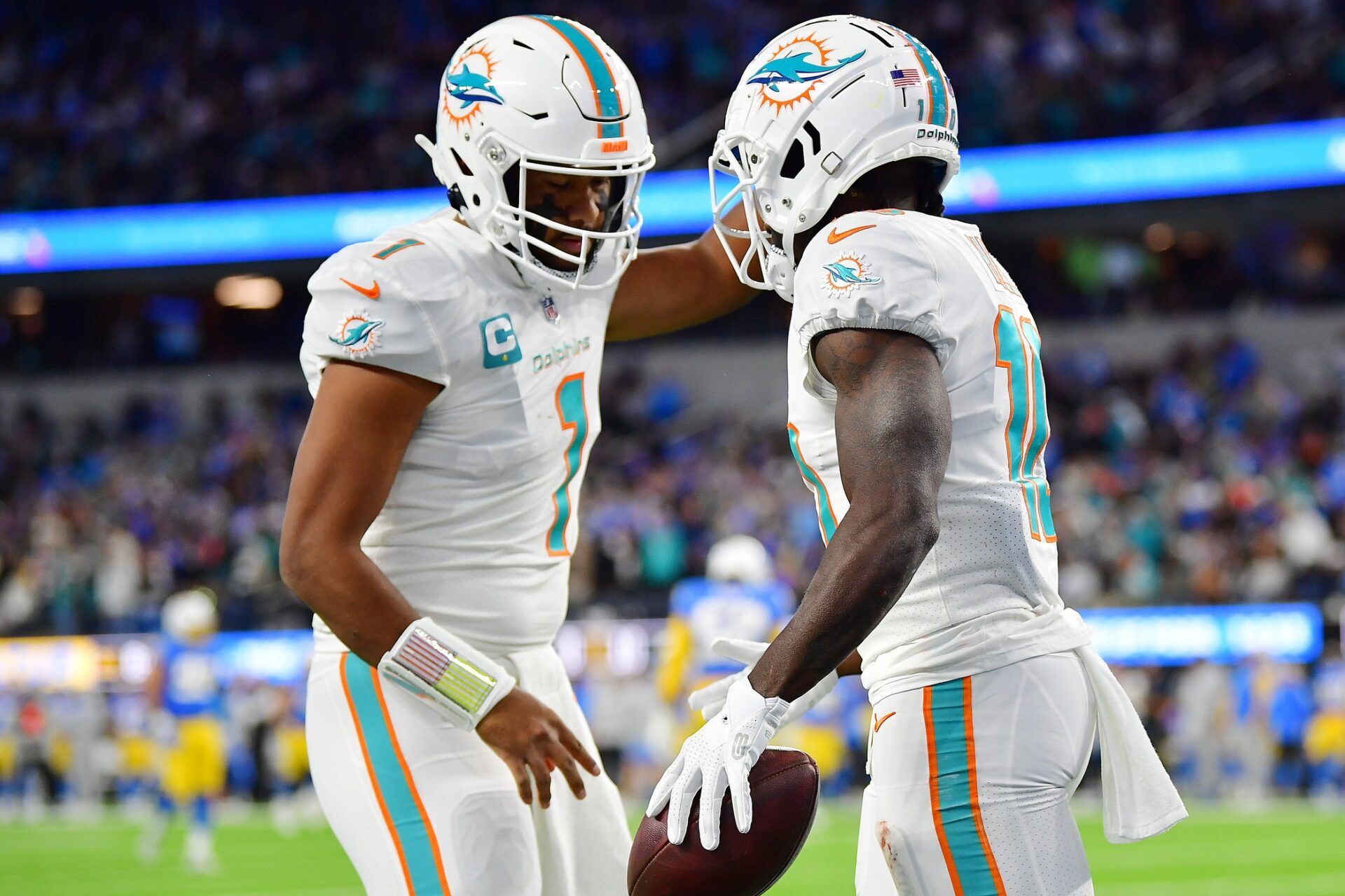 Miami Dolphins wide receiver Tyreek Hill (10) celebrates his touchdown scored against the Los Angeles Chargers with quarterback Tua Tagovailoa (1) during the first half at SoFi Stadium.