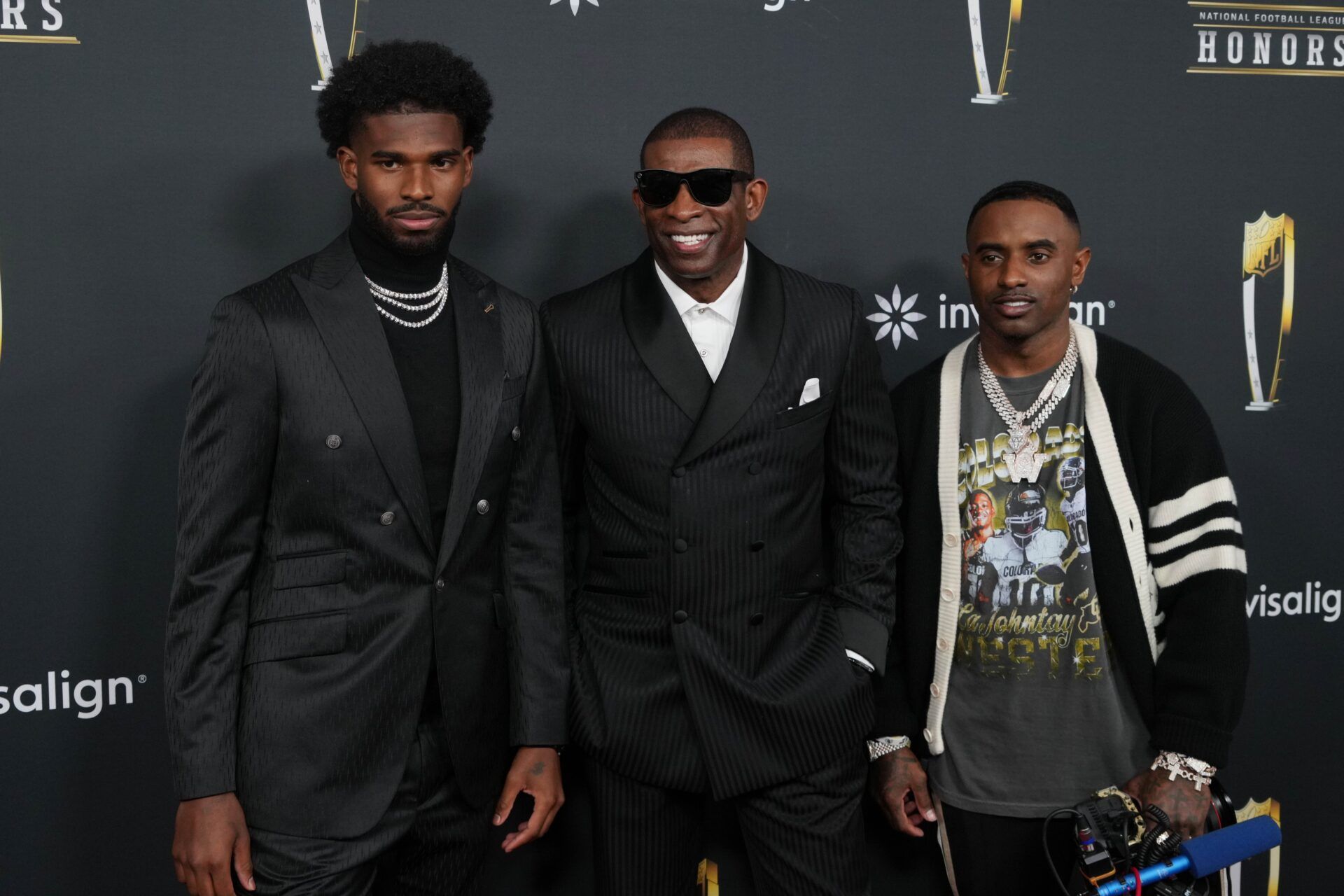 Deion Sanders with his sons Shedeur Sanders (left) and Deion Sanders Jr. (right) on the red carpet before Super Bowl LIX NFL Honors at Saenger Theatre.