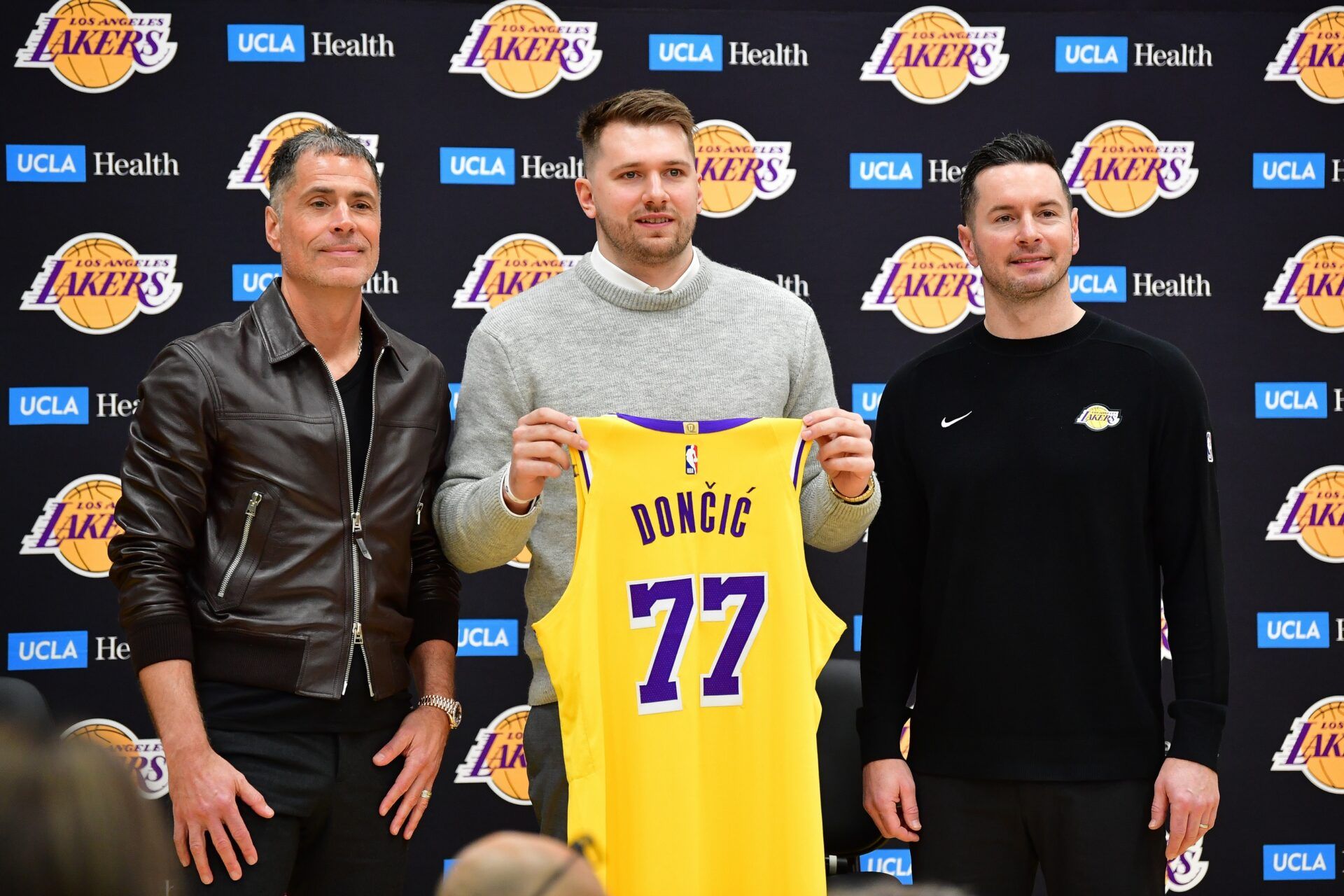 Los Angeles Lakers guard Luka Doncic poses for photos with general manager Rob Pelinka and head coach JJ Redick at UCLA Health Training Center.