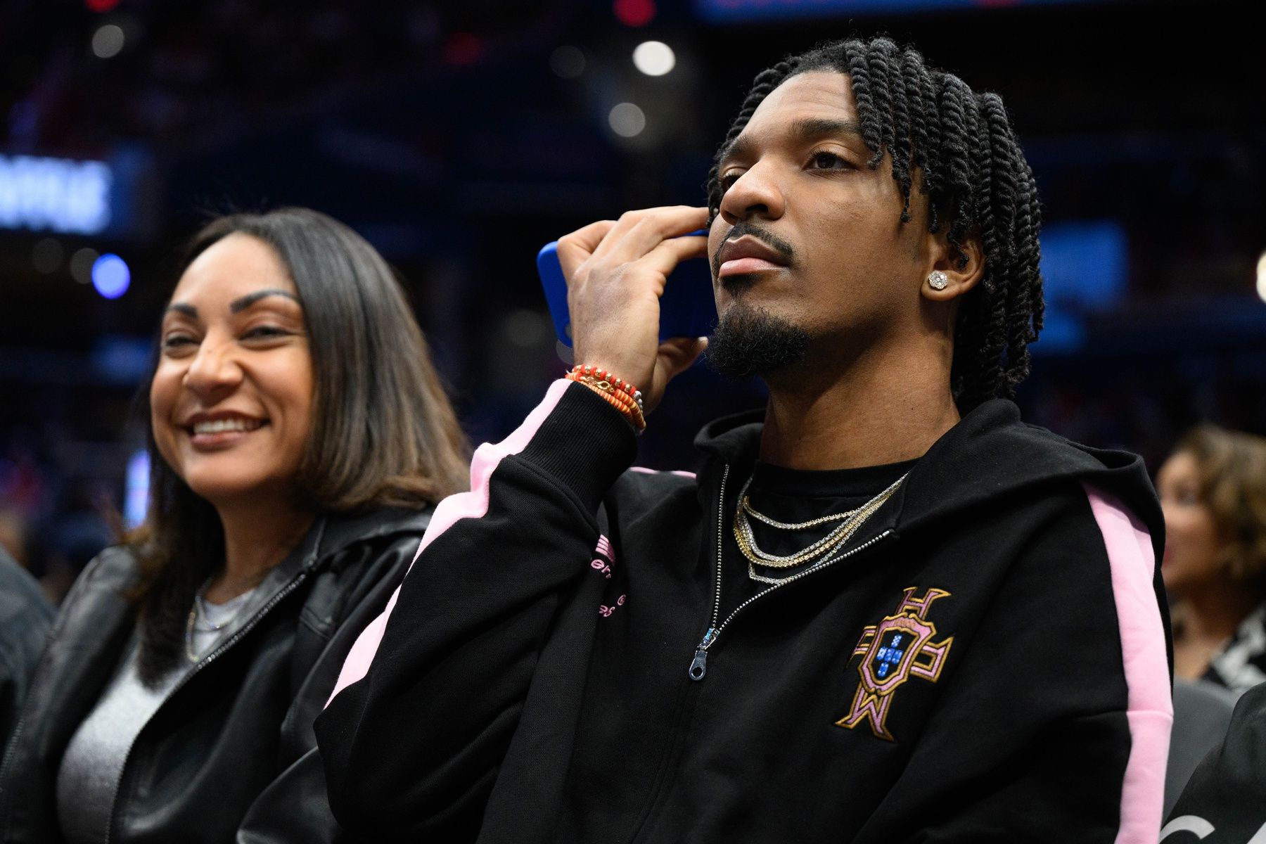 Washington Commanders quarterback Jayden Daniels sits courtside during the game between the Washington Wizards and the New York Knicks at Capital One Arena.