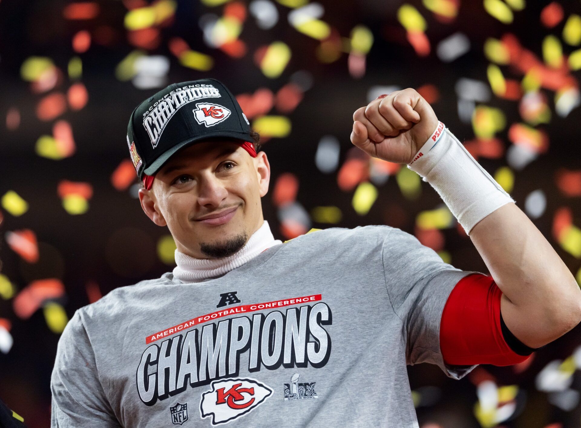 Confetti falls as Kansas City Chiefs quarterback Patrick Mahomes celebrates after defeating the Buffalo Bills during the AFC Championship game at GEHA Field at Arrowhead Stadium.