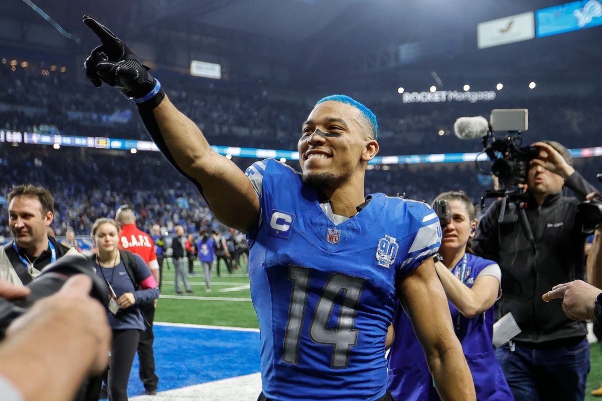 Detroit Lions wide receiver Amon-Ra St. Brown celebrates the 31-23 win over the Tampa Bay Buccaneers in the NFC divisional round at Ford Field in Detroit on Sunday, Jan. 21, 2024. His hair is dyed blue.